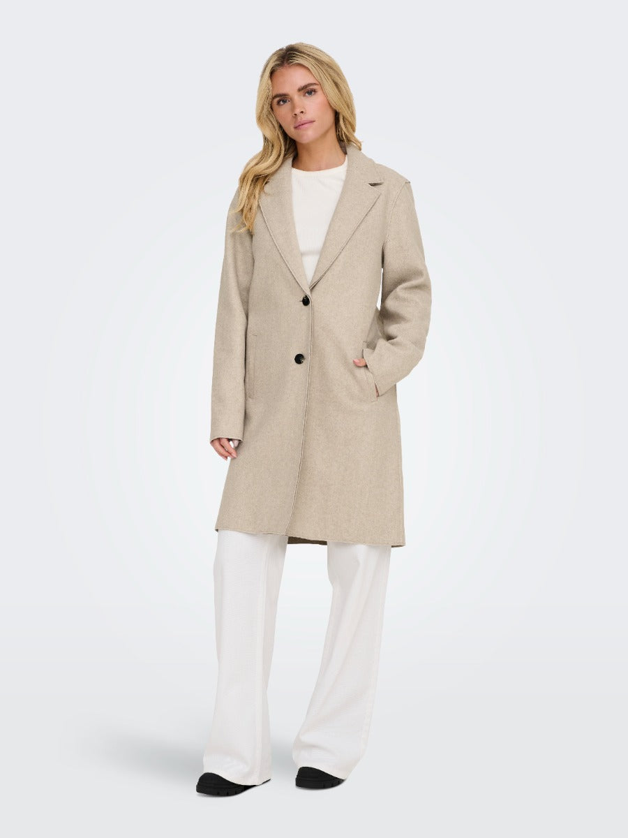 Light beige ONLY Carrie Bonded 3 Button Coat by Only styled with white pants and black shoes for sophisticated outerwear look