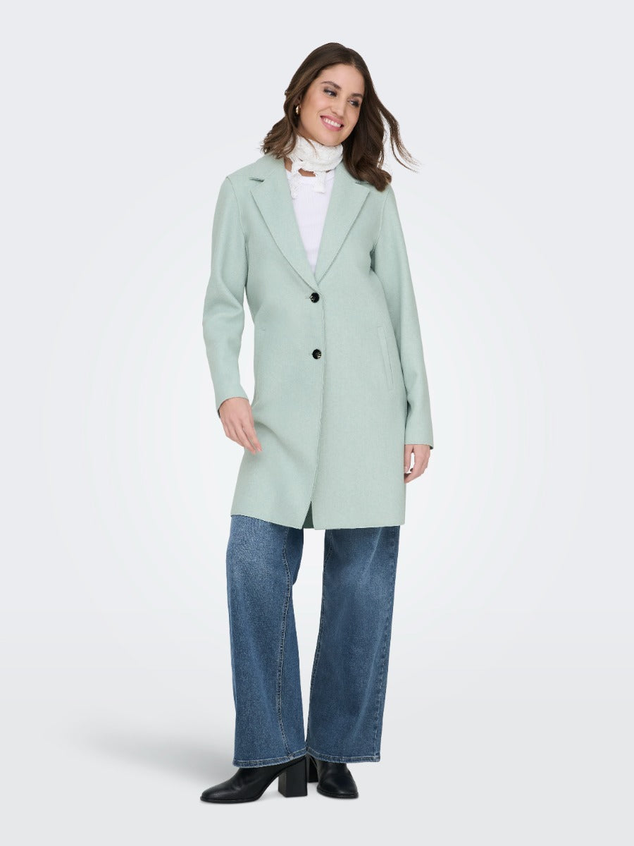 ONLY Carrie Bonded 3 Button Coat in soft pastel green, styled with denim jeans and black boots by Only Outerwear.