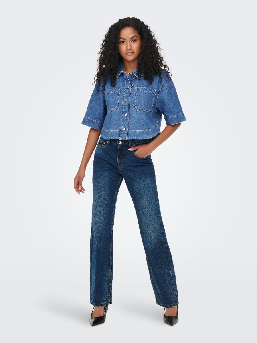 Model in blue denim ONLY Cleo Short Sleeve Denim Shirt by Only paired with dark blue jeans and black heels