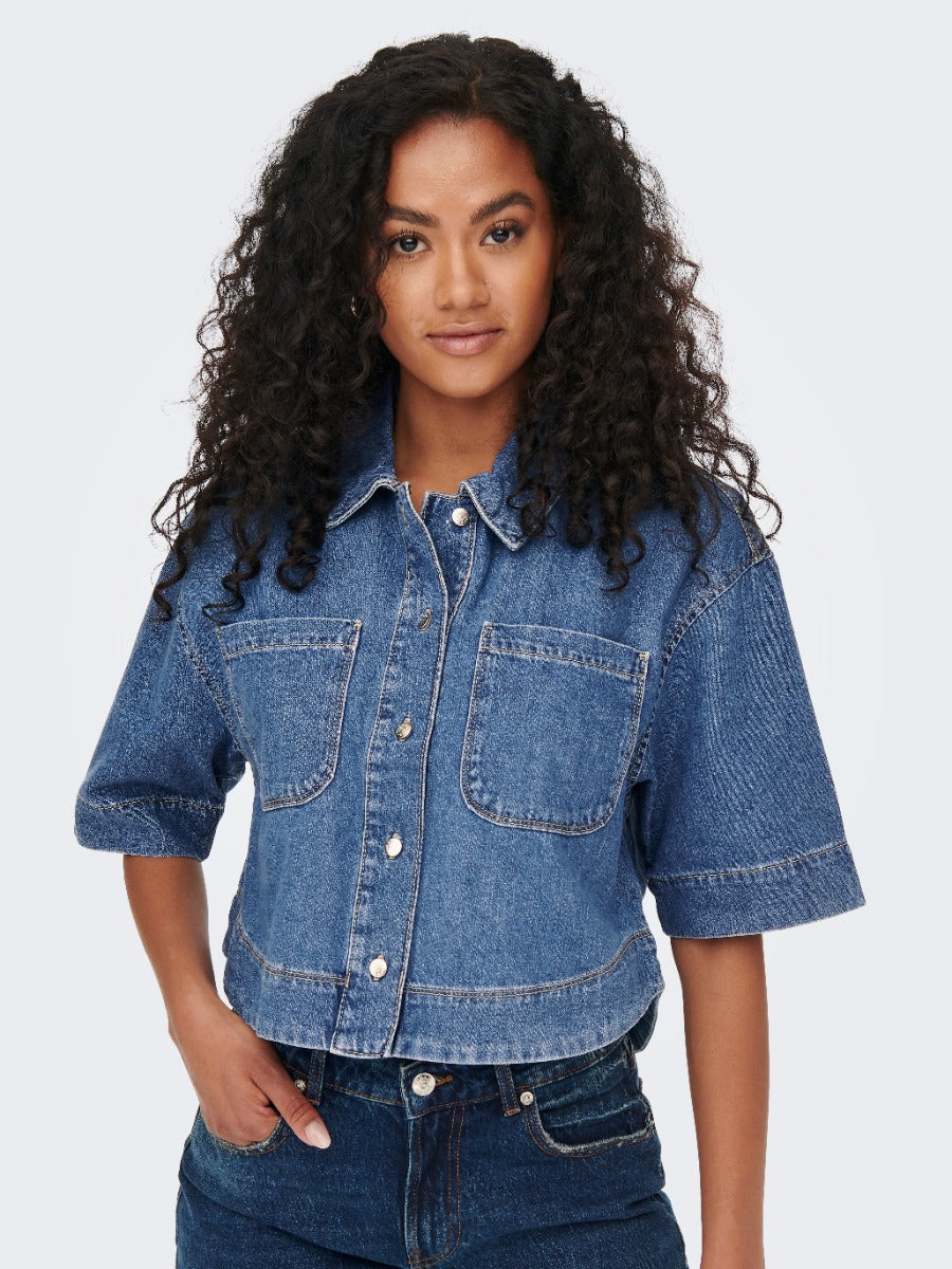 ONLY Cleo Short Sleeve Denim Shirt by Only in medium blue wash with front pockets and button closure top