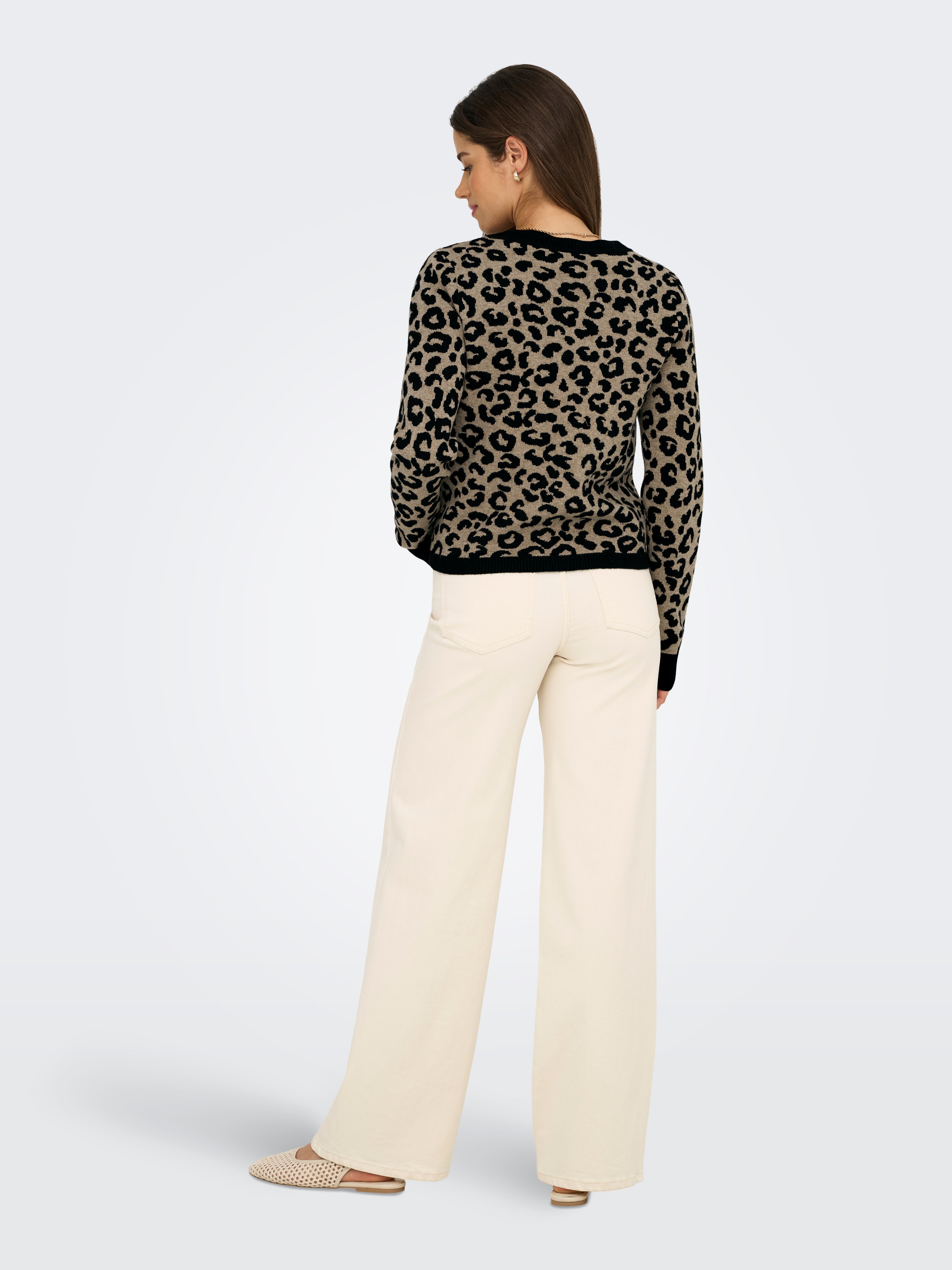 Leopard print long-sleeve sweater paired with high-waisted wide-leg cream pants and woven pointed flats.