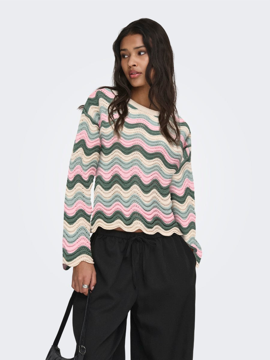 ONLY Lasa Crochet Wave Crewneck Sweater by Only in soft pastel waves, paired with black pants and a black handbag.