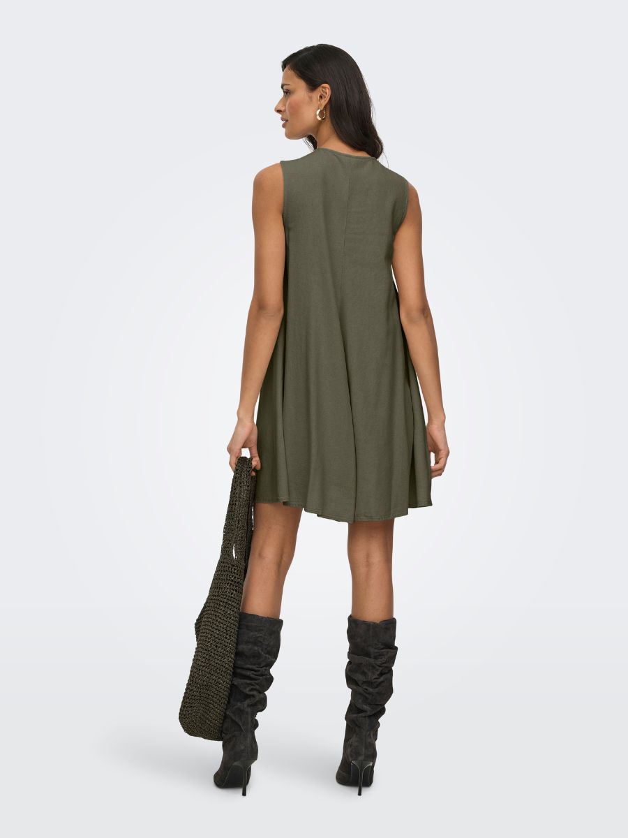 Back view of Jacqueline De Yong Linen Dress in olive green paired with dark slouchy boots and a textured handbag by Jacqueline De Yong