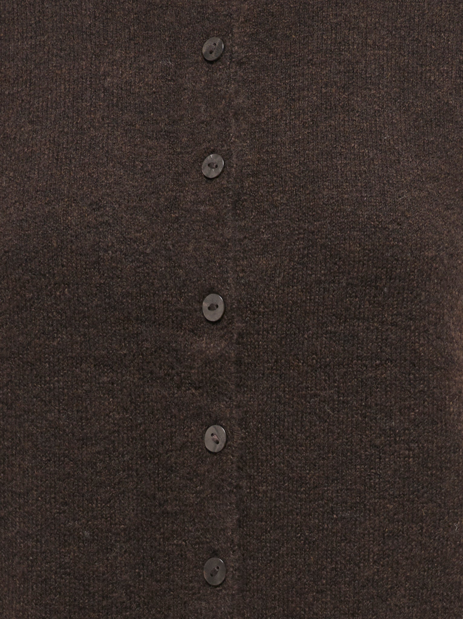 Close-up of a brown knitted sweater with a vertical row of matching buttons down the center front.