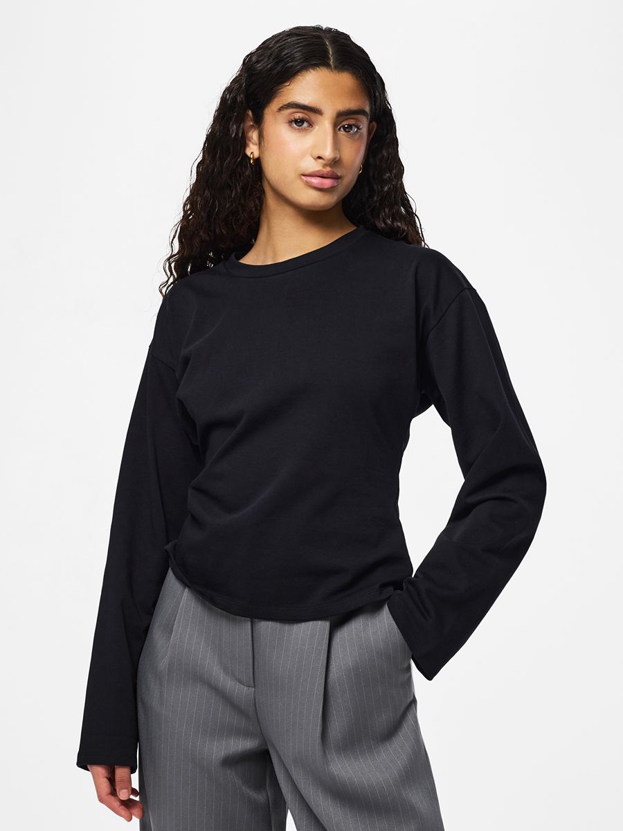 Amy Back Zip Long Sleeve Top by Pieces in black paired with grey pinstripe trousers for a stylish look
