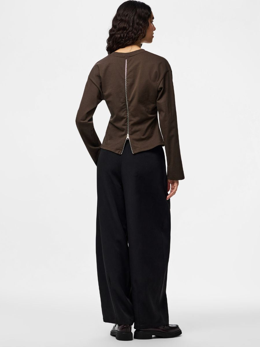 Amy Back Zip Long Sleeve Top from Pieces in brown with visible back zipper, paired with black wide-leg pants.