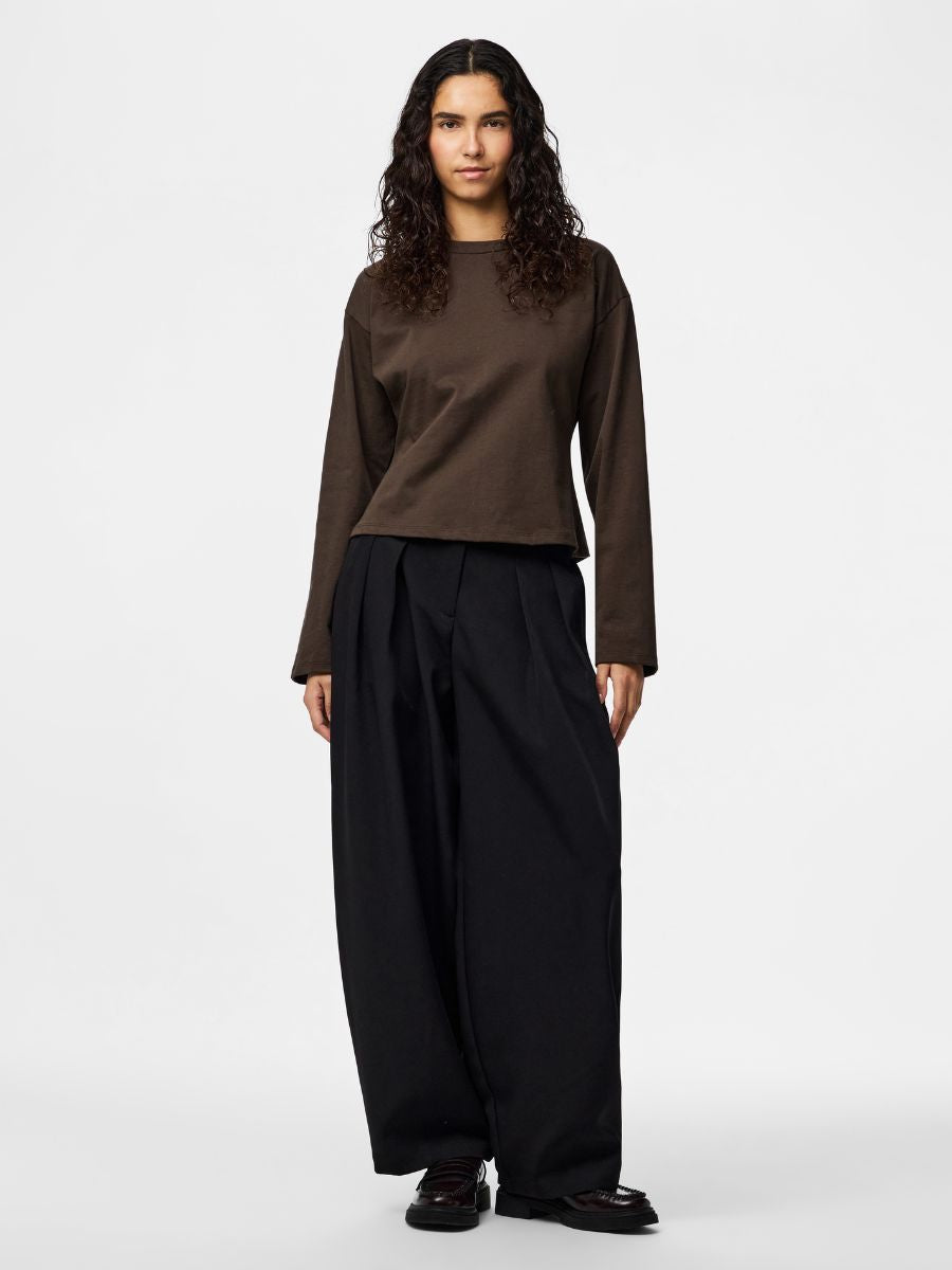 Amy Back Zip Long Sleeve Top by Pieces in brown cotton paired with wide-leg black trousers against a white background