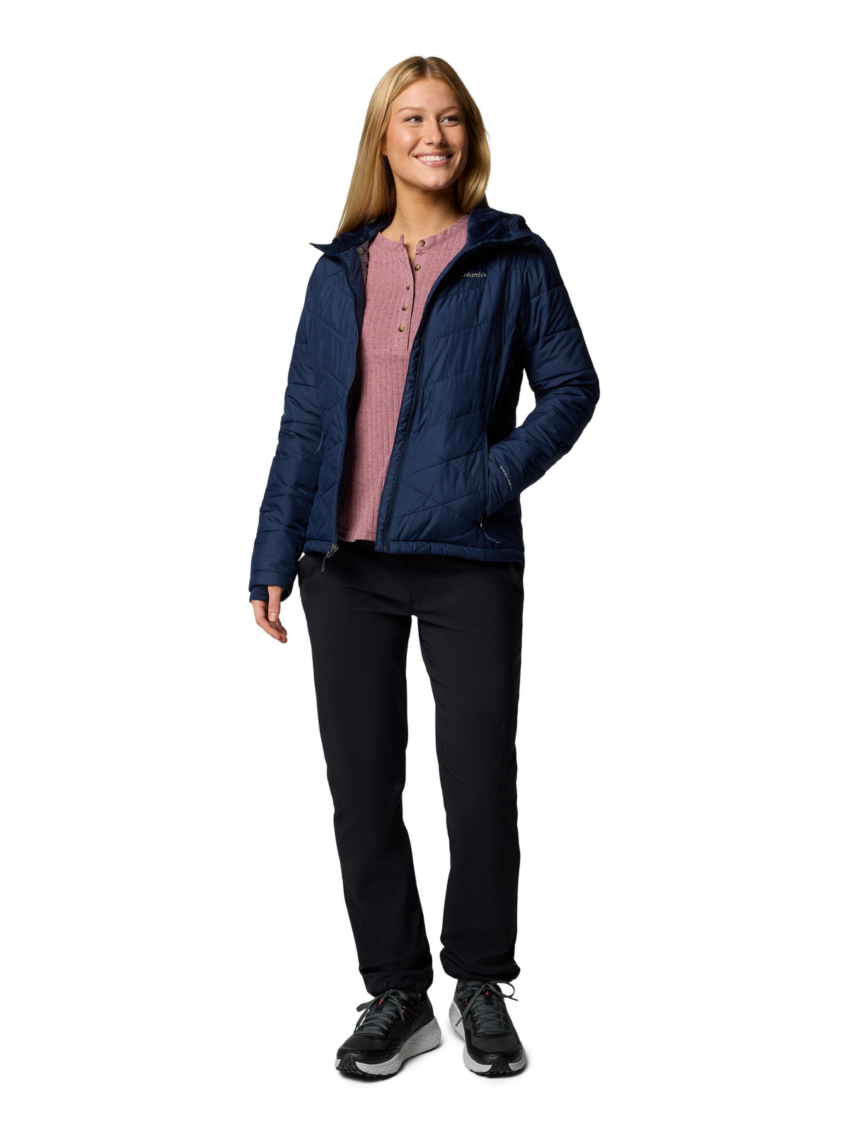 Model wearing navy Columbia Heavenly Short Hooded Omni-Heat Jacket with black pants and sneakers outdoors