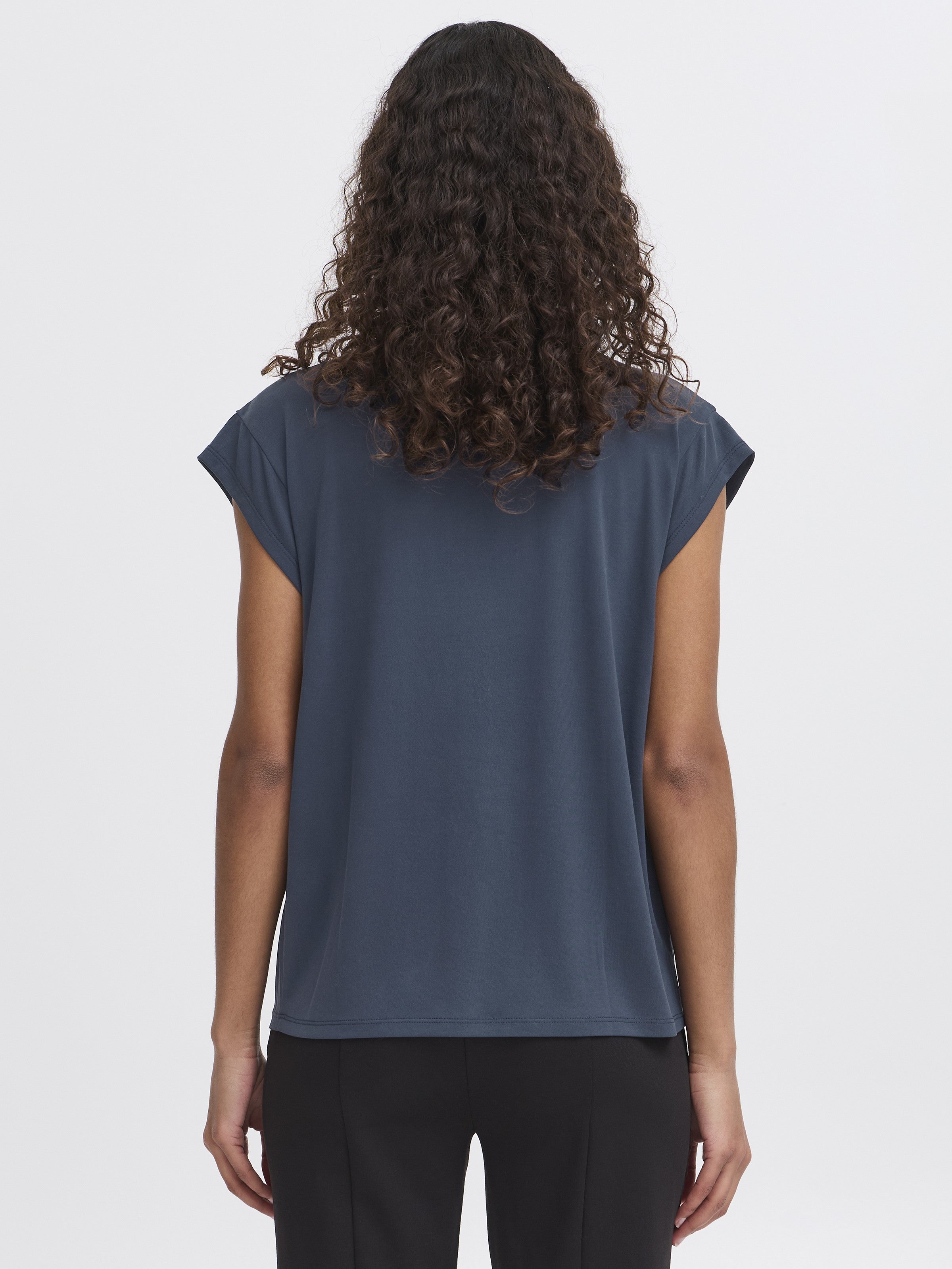 Back view of Ichi Lisken Top in navy blue, paired with black pants, by Ichi brand.