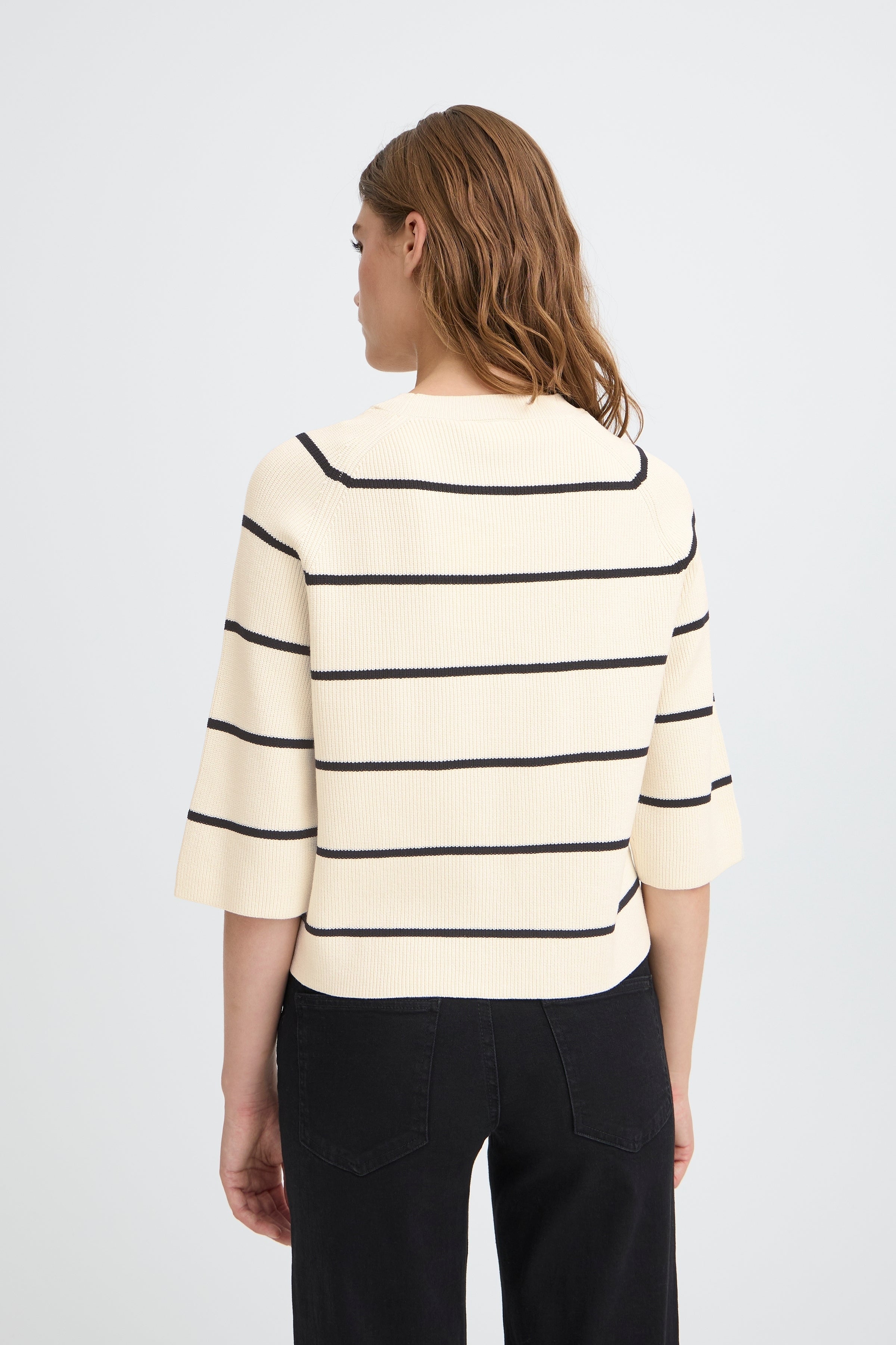 Back view of Ichi Boston ¾ Sleeve Crew Sweater in beige with black stripes, paired with black pants by Ichi.