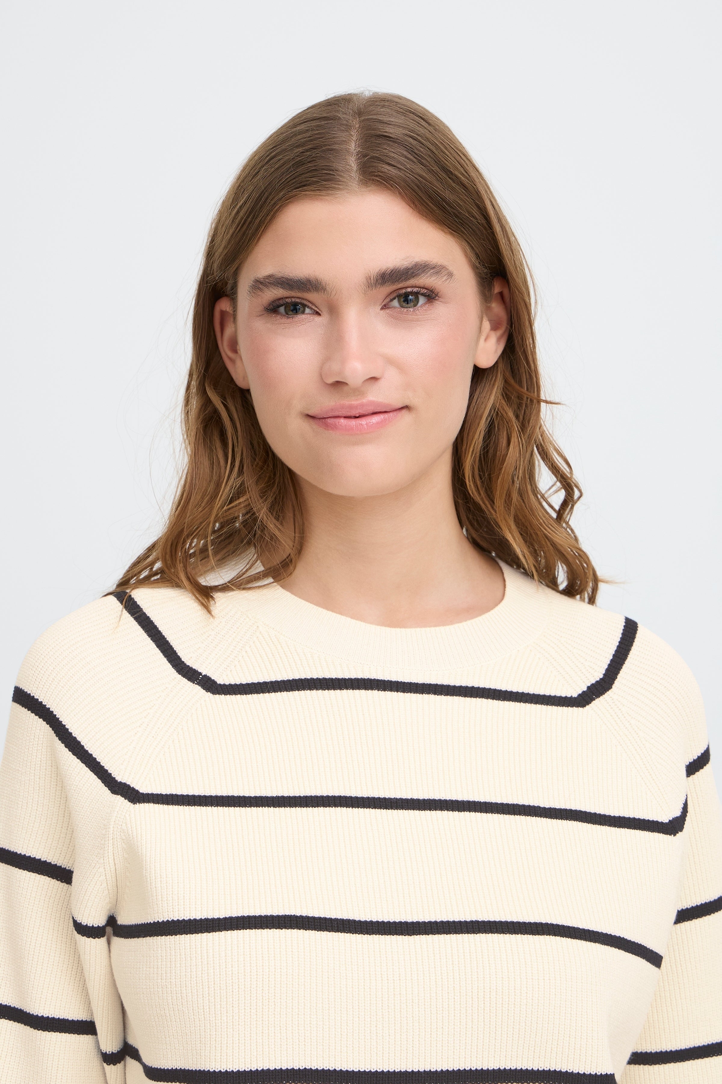 Close-up of a person wearing an Ichi Boston ¾ Sleeve Crew Sweater in beige with black stripes, a stylish sweater by Ichi.