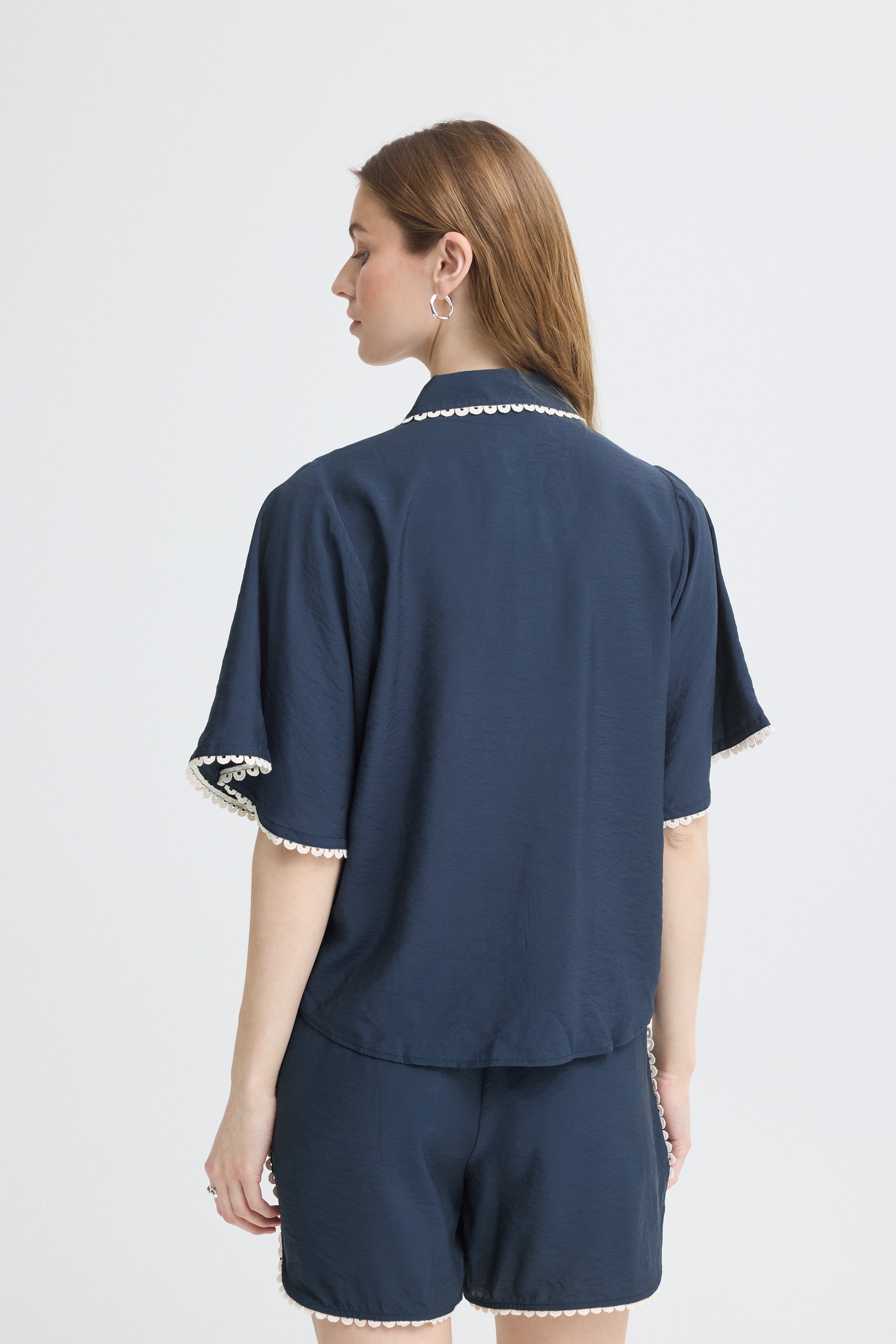 Back view of Ichi Leni Ladder Short Sleeve Shirt in navy with white trim detailing by Ichi