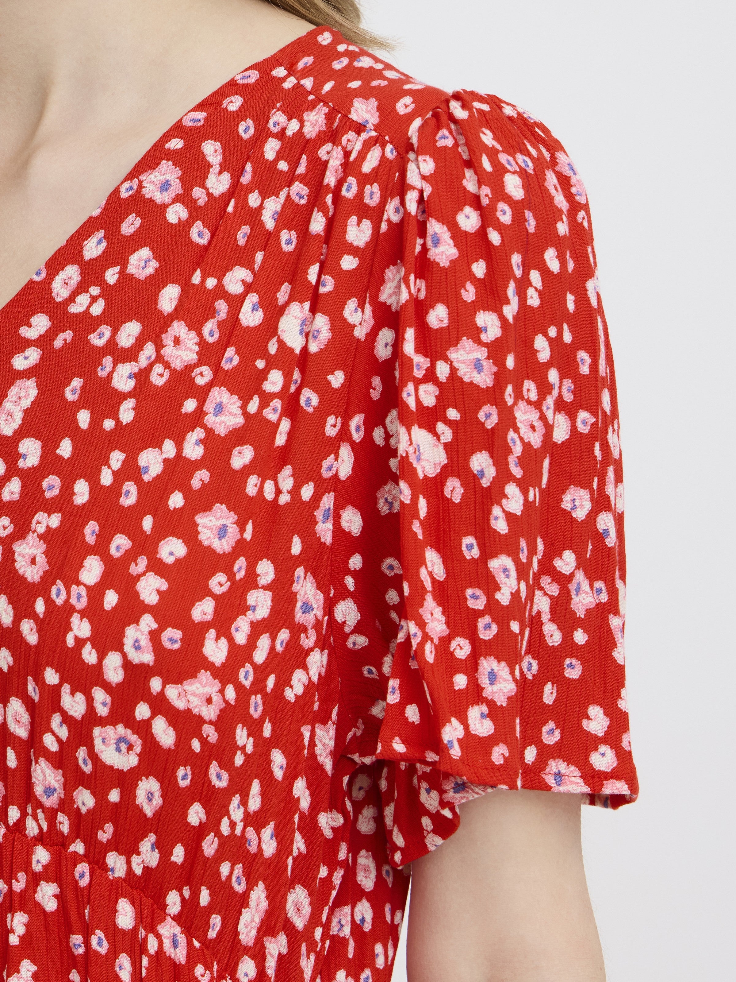 Close-up of red floral fabric and short sleeve detail on Ichi Marrakech Short Sleeve Maxi Dress by Ichi