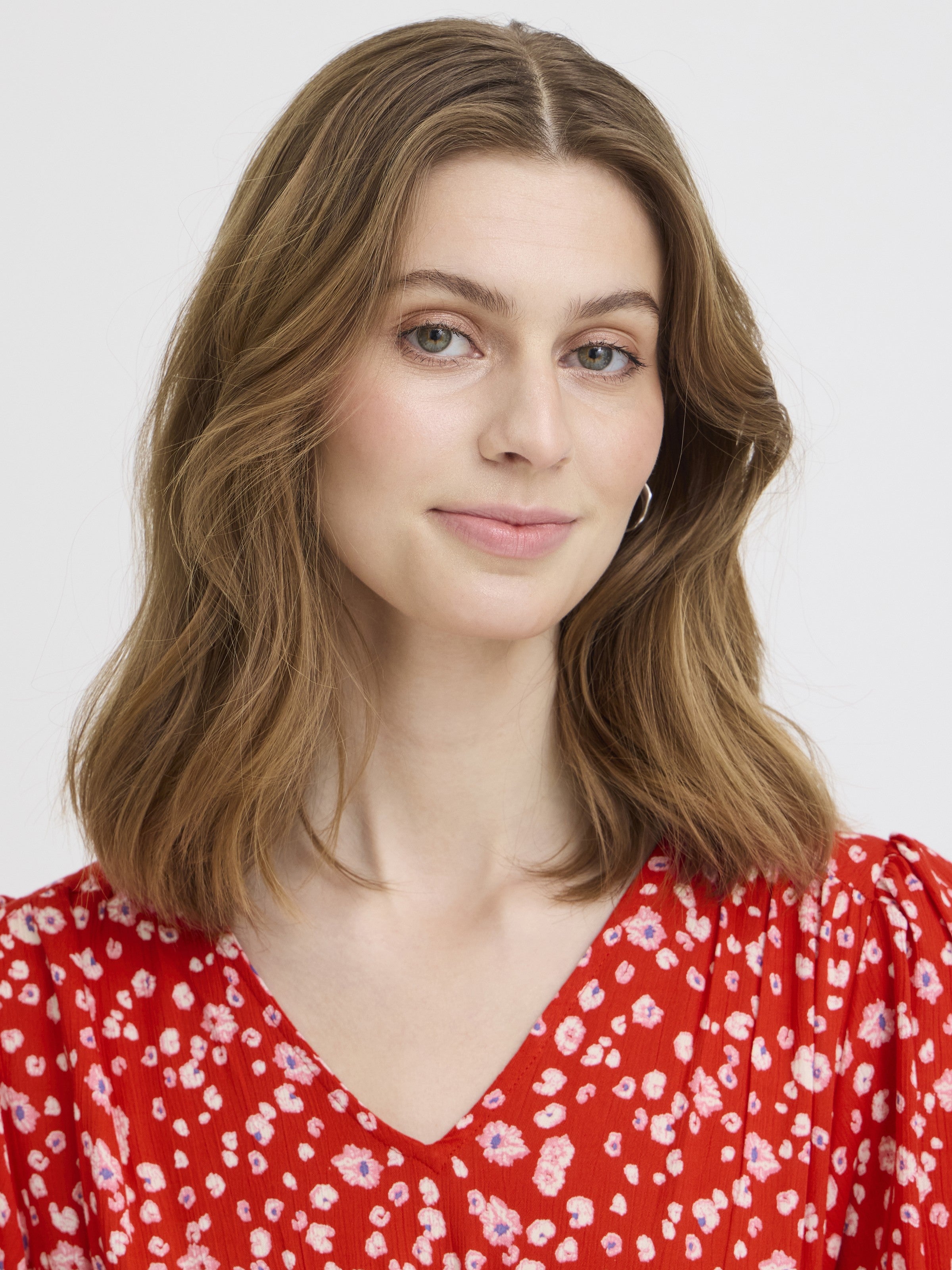 Close-up of a model with light brown hair wearing the red patterned Ichi Marrakech Short Sleeve Maxi Dress by Ichi.