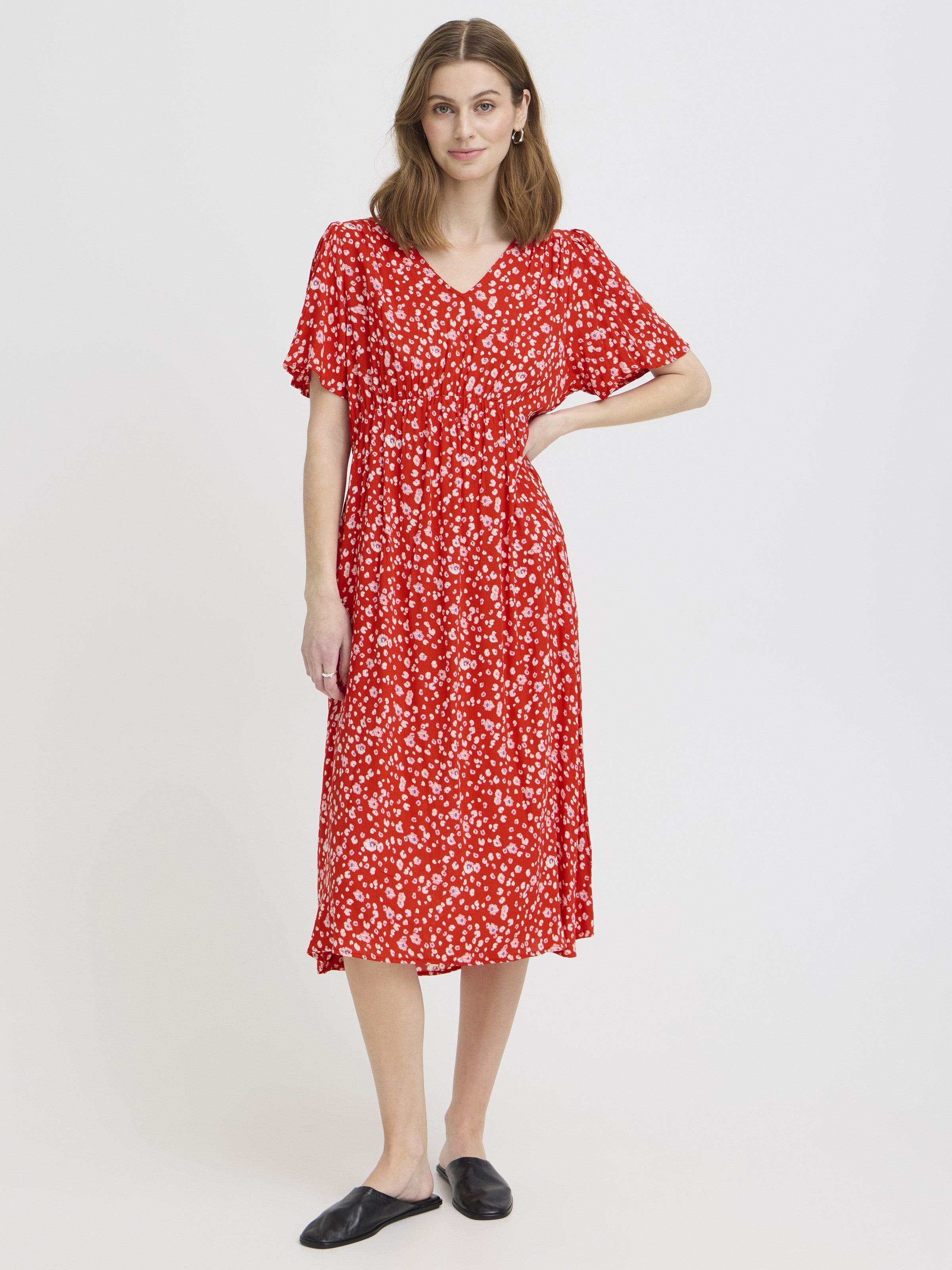 Red floral Ichi Marrakech Short Sleeve Maxi Dress by Ichi with a relaxed fit and v-neckline styled with black slip-on shoes.