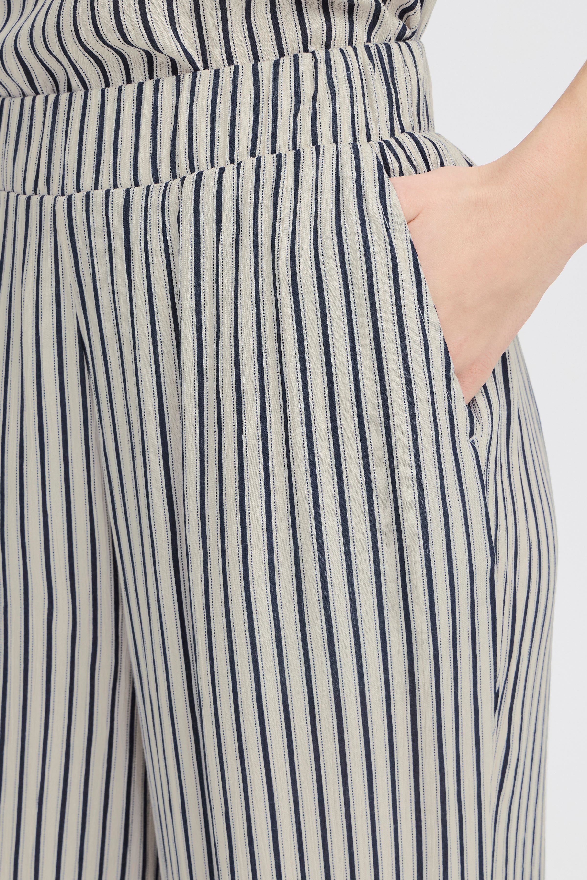 Close-up of striped beige and navy Ichi Marrakech Cropped Trousers pocket detail with elastic waistband