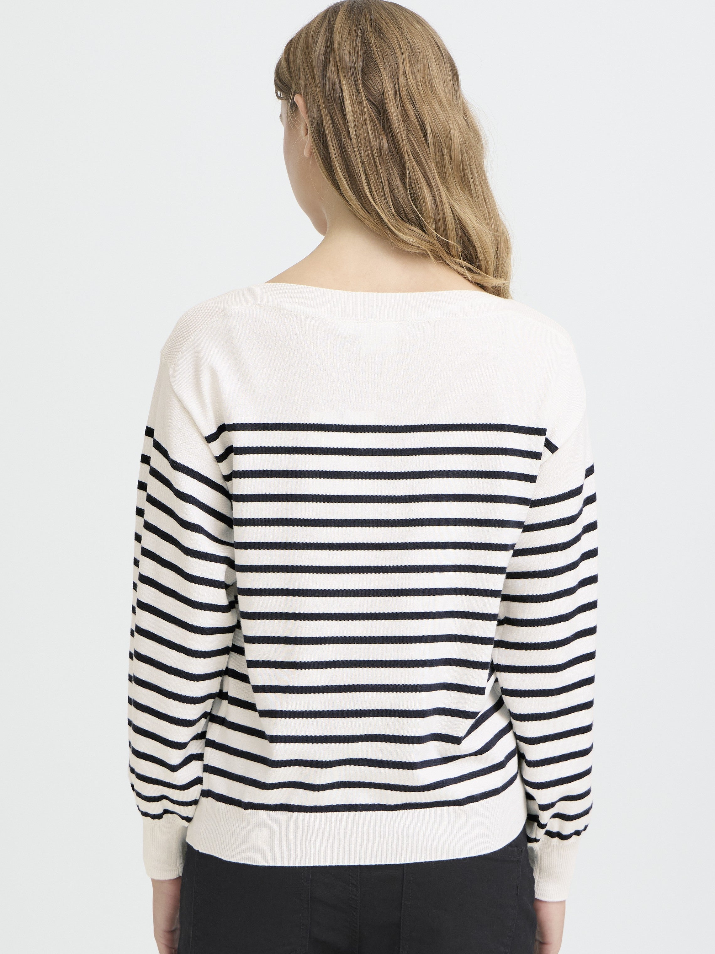 Back view of Ichi Boat Neck Sweater in white with black stripes, styled by Ichi, a cozy sweater top.