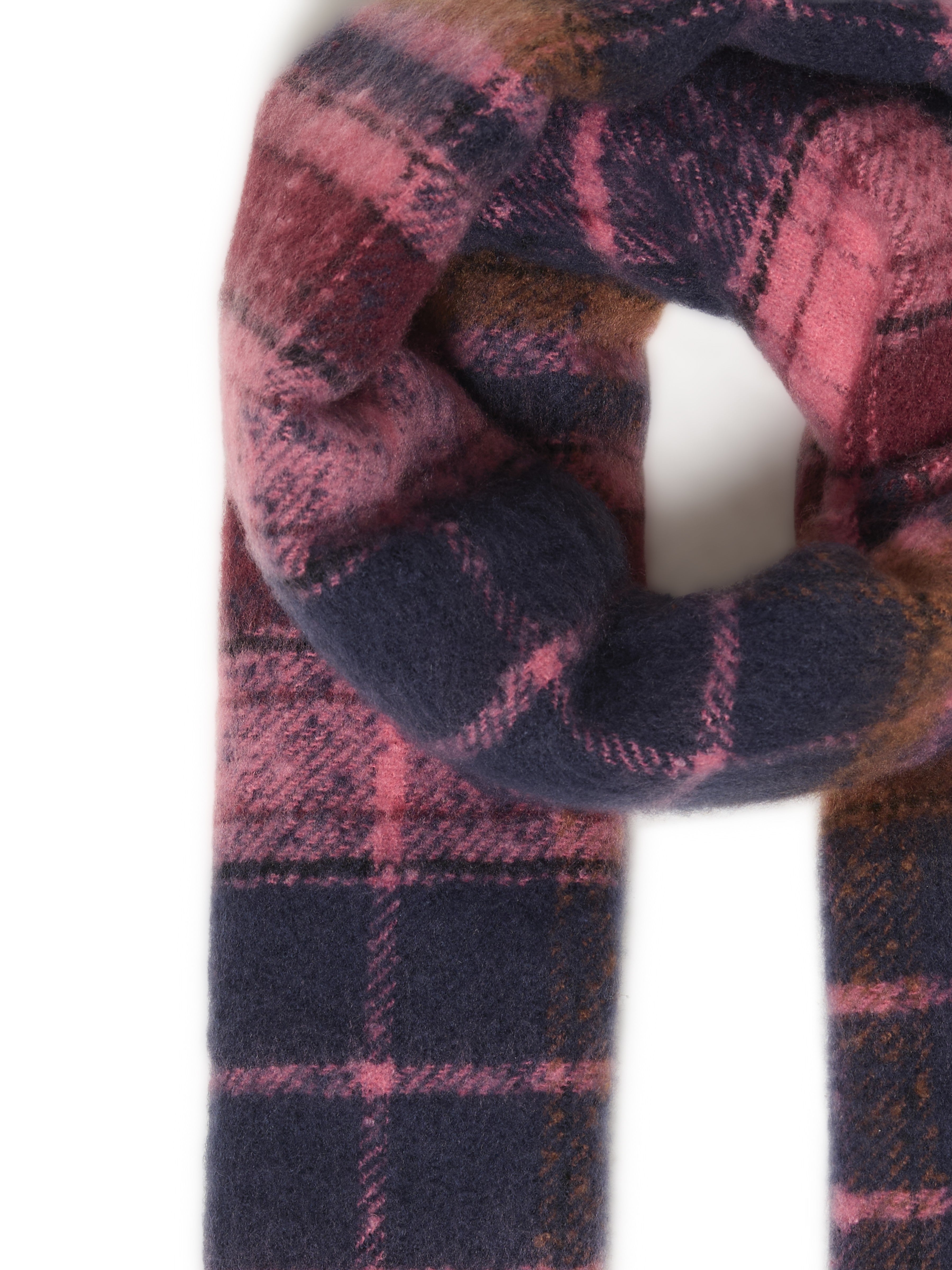 Close-up of a soft wool scarf with pink, navy, and brown plaid pattern twisted in a loop.