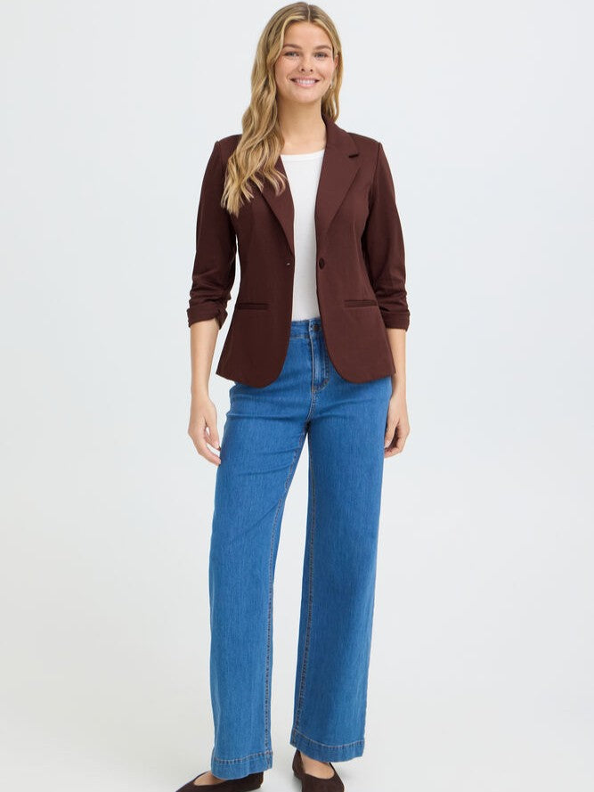 Fransa Gathered Sleeve Stretch Blazer in brown with tailored lapels and ruched sleeves, styled with casual denim jeans.