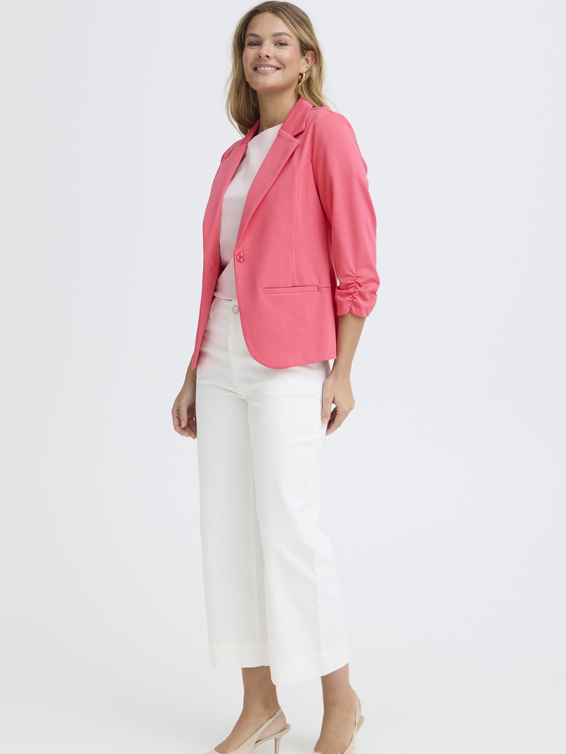 Fransa Gathered Sleeve Stretch Blazer in coral red paired with white cropped pants and beige heels on a model