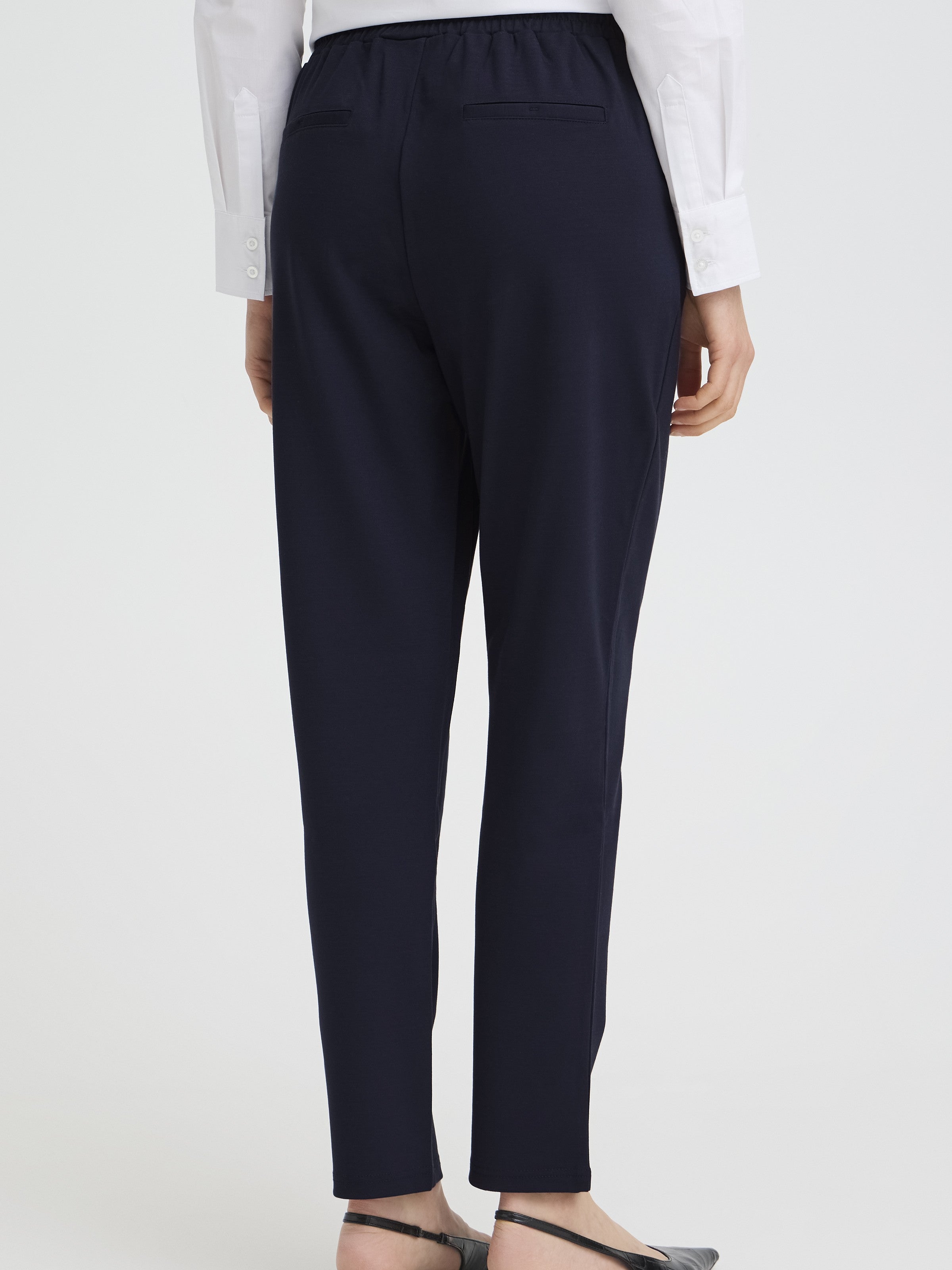 Back view of navy Fransa Jenns Stretch Tailored Pants styled with a white shirt and black flats