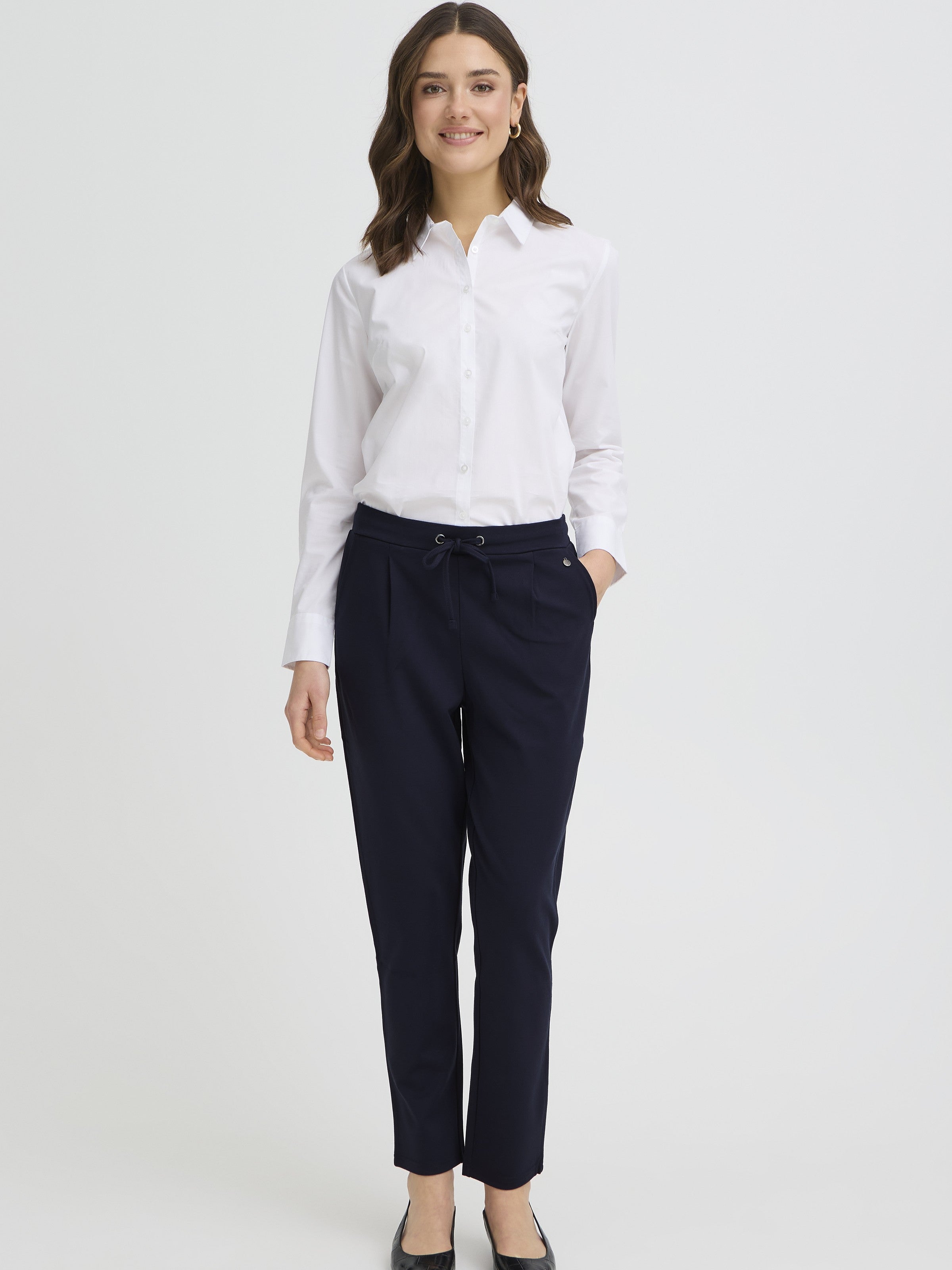 Fransa Jenns Stretch Tailored Pants in navy worn with a white button-up shirt, styled for a polished look.