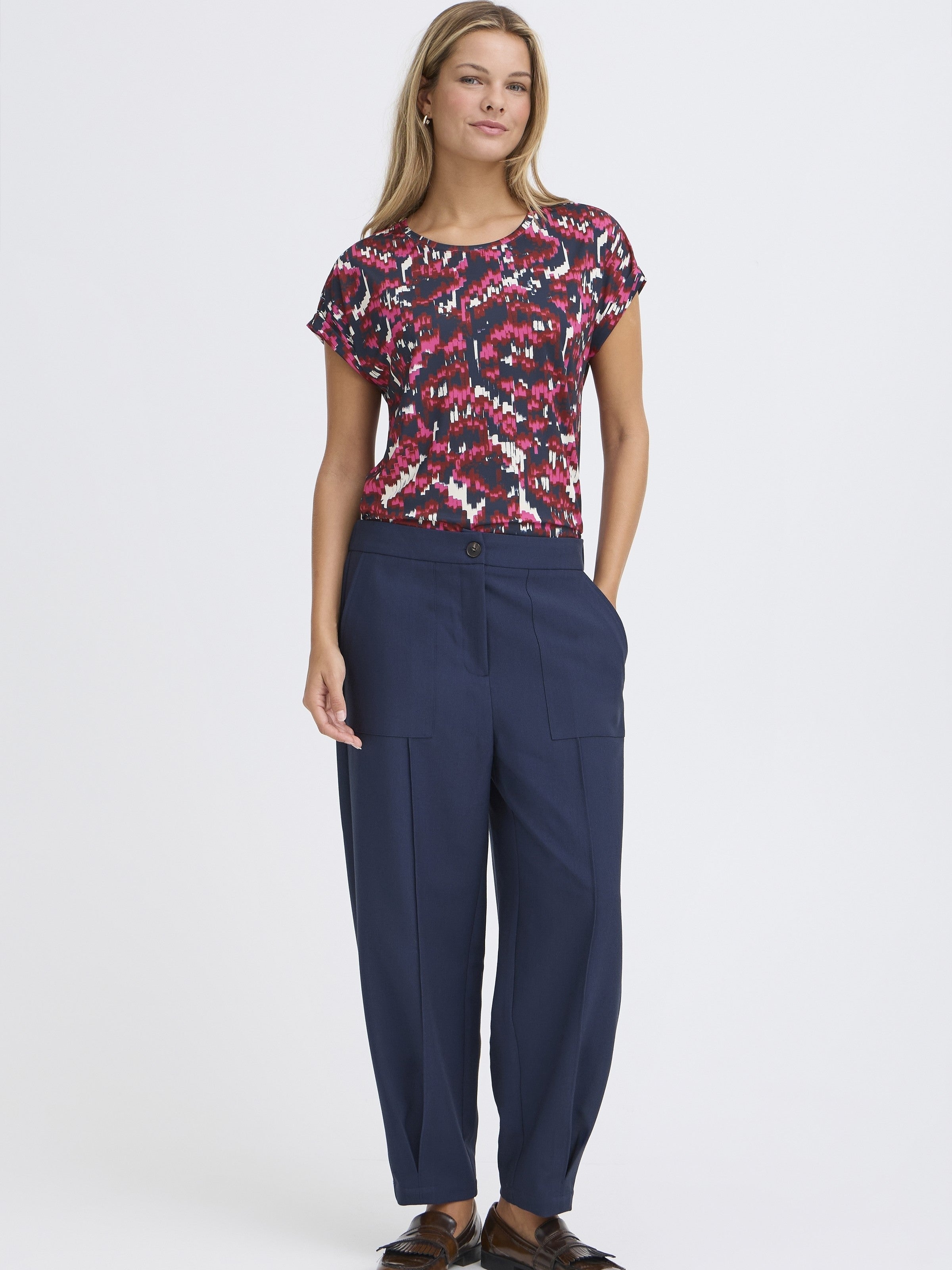 Fransa Seen Short Sleeve Crew Neck Top in red and black pattern styled with navy trousers by Fransa