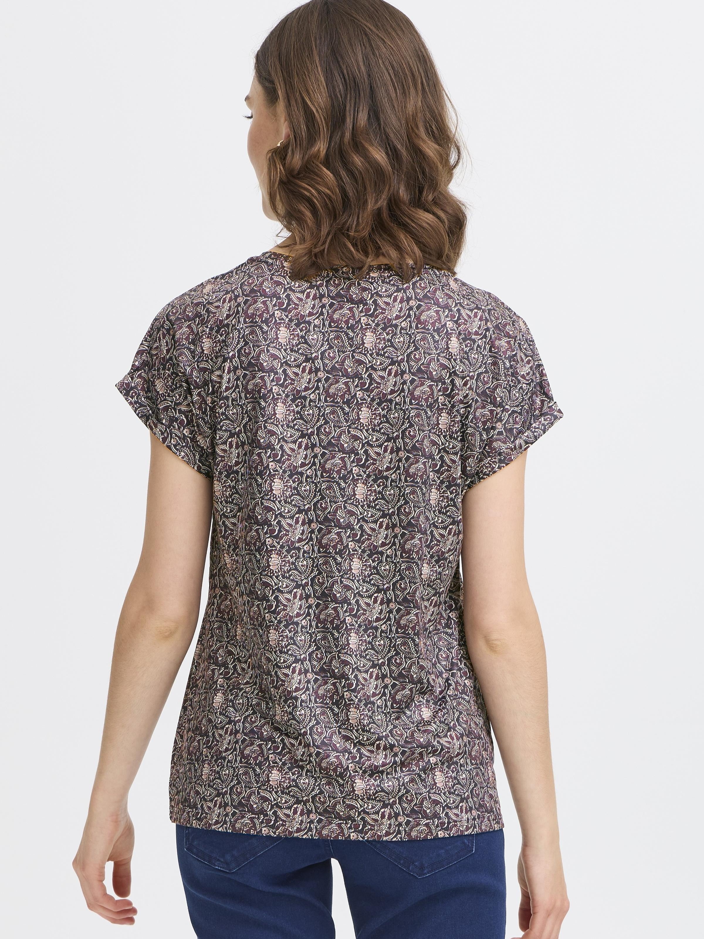 Back view of a floral patterned Fransa Seen Short Sleeve Crew Neck Top in dark tones paired with blue jeans