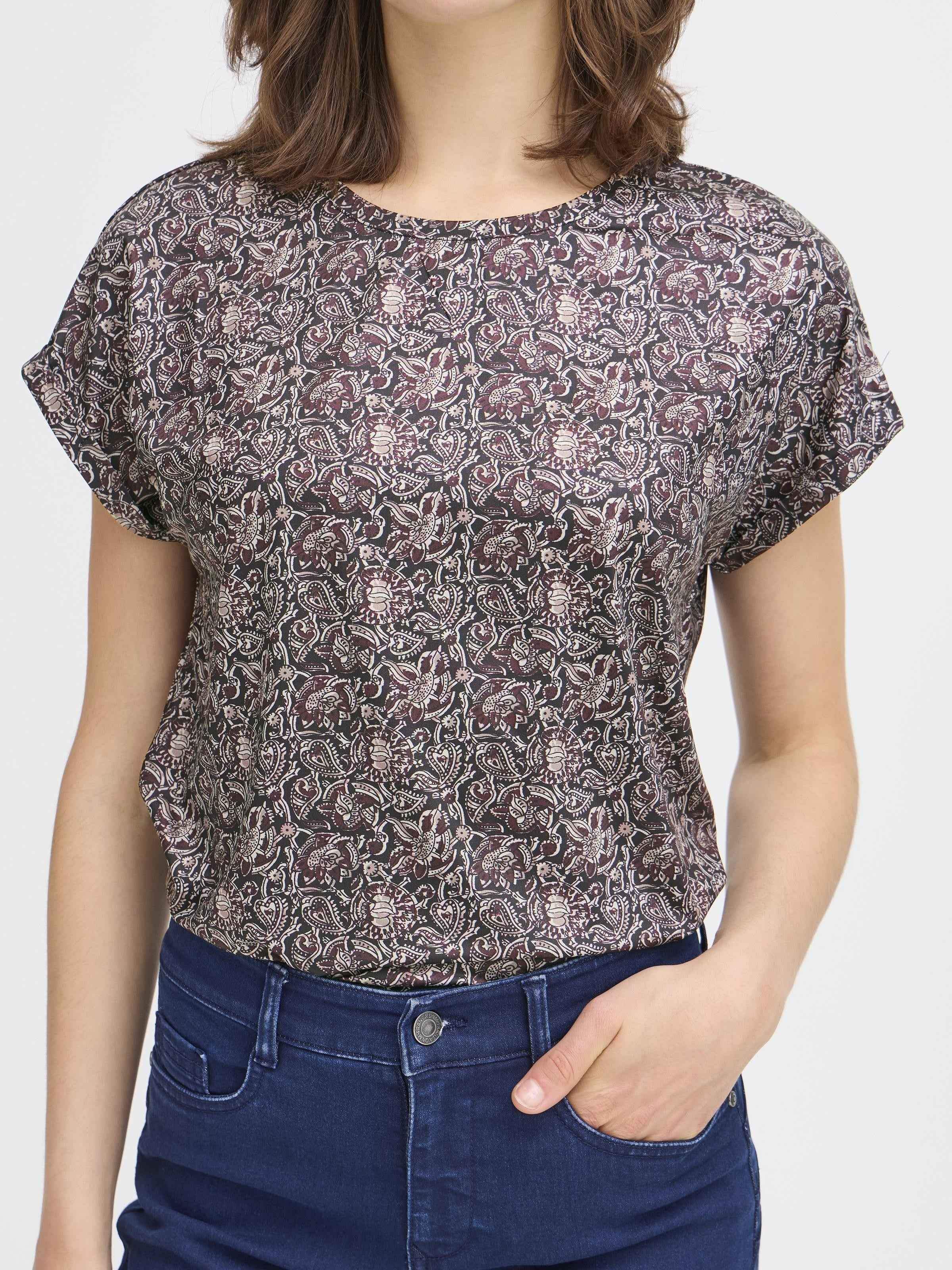 Fransa Seen Short Sleeve Crew Neck Top in a dark floral pattern paired with dark blue denim jeans.