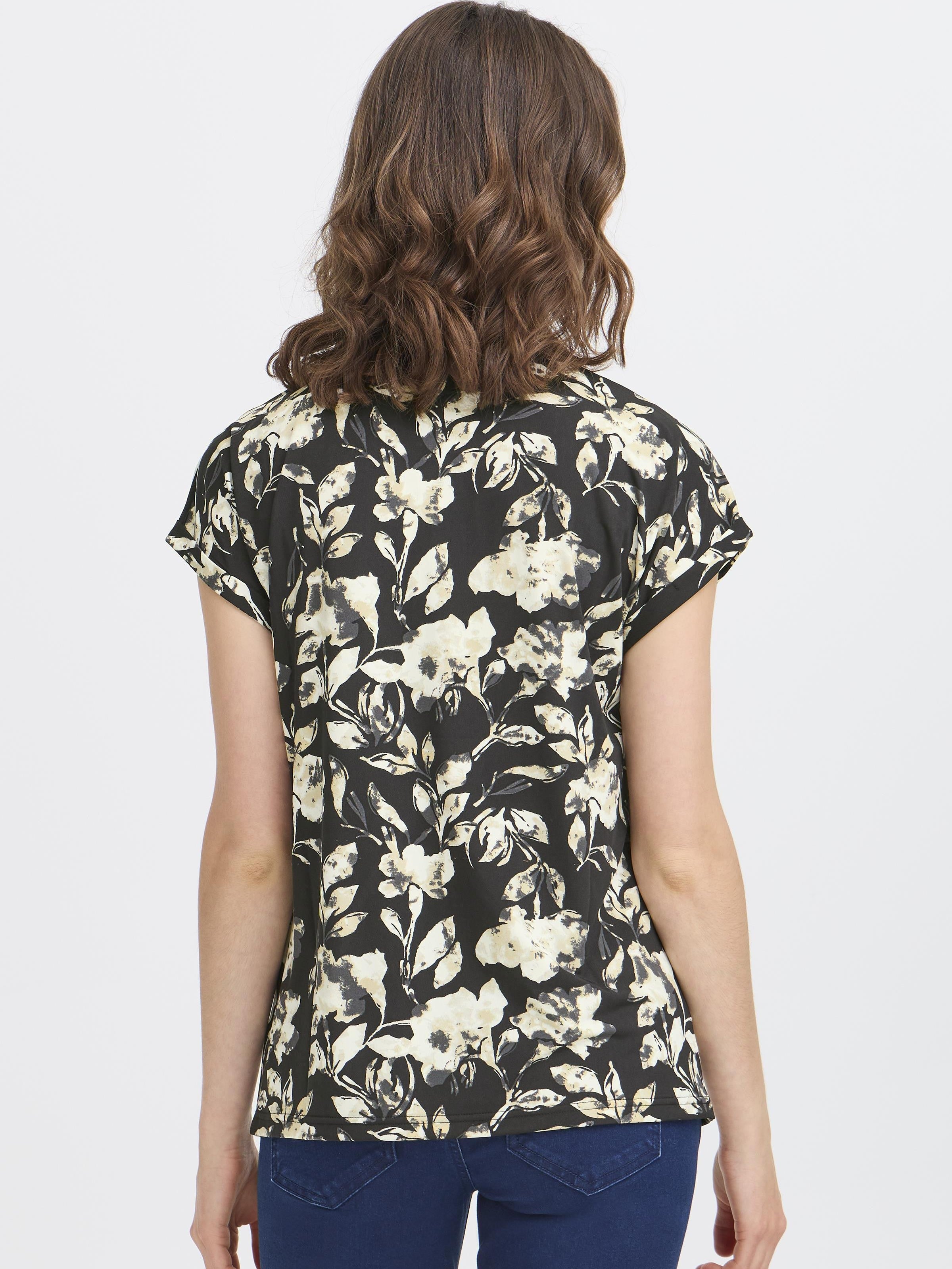 Back view of floral patterned Fransa Seen Short Sleeve Crew Neck Top on model with brown wavy hair and blue jeans