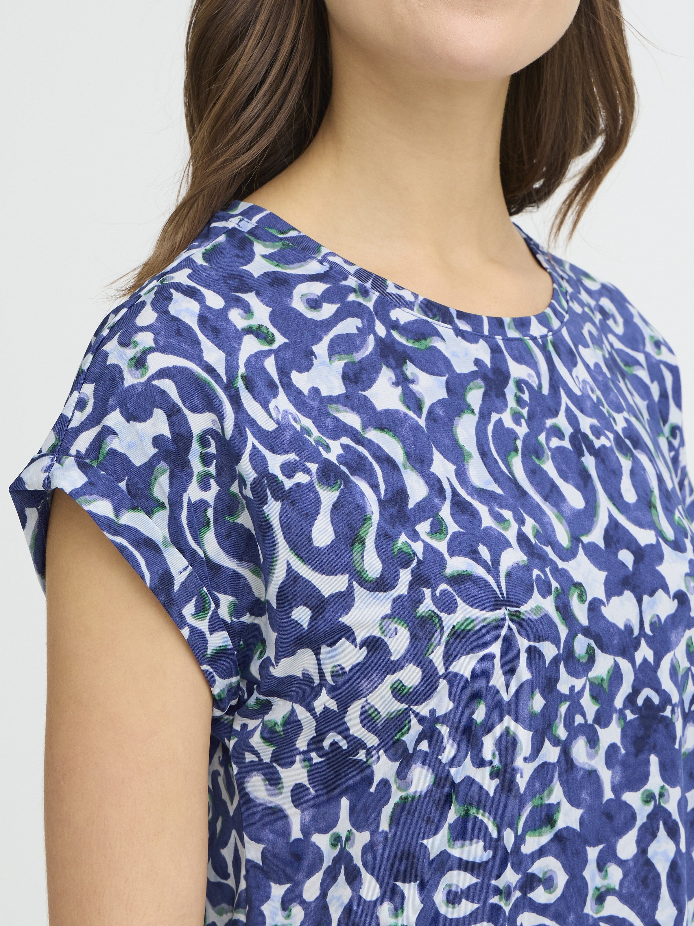 Close-up of blue patterned fabric on Fransa Seen Short Sleeve Crew Neck Top by Fransa, featuring a relaxed fit and short sleeves.