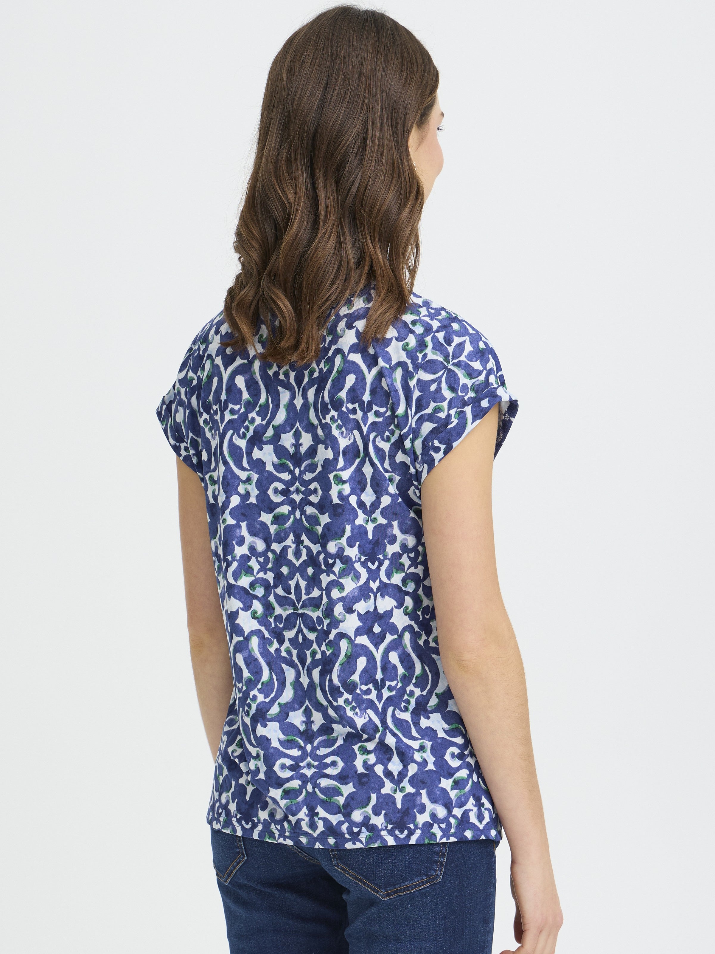 Fransa Seen Short Sleeve Crew Neck Top in blue patterned fabric paired with dark denim jeans back view.