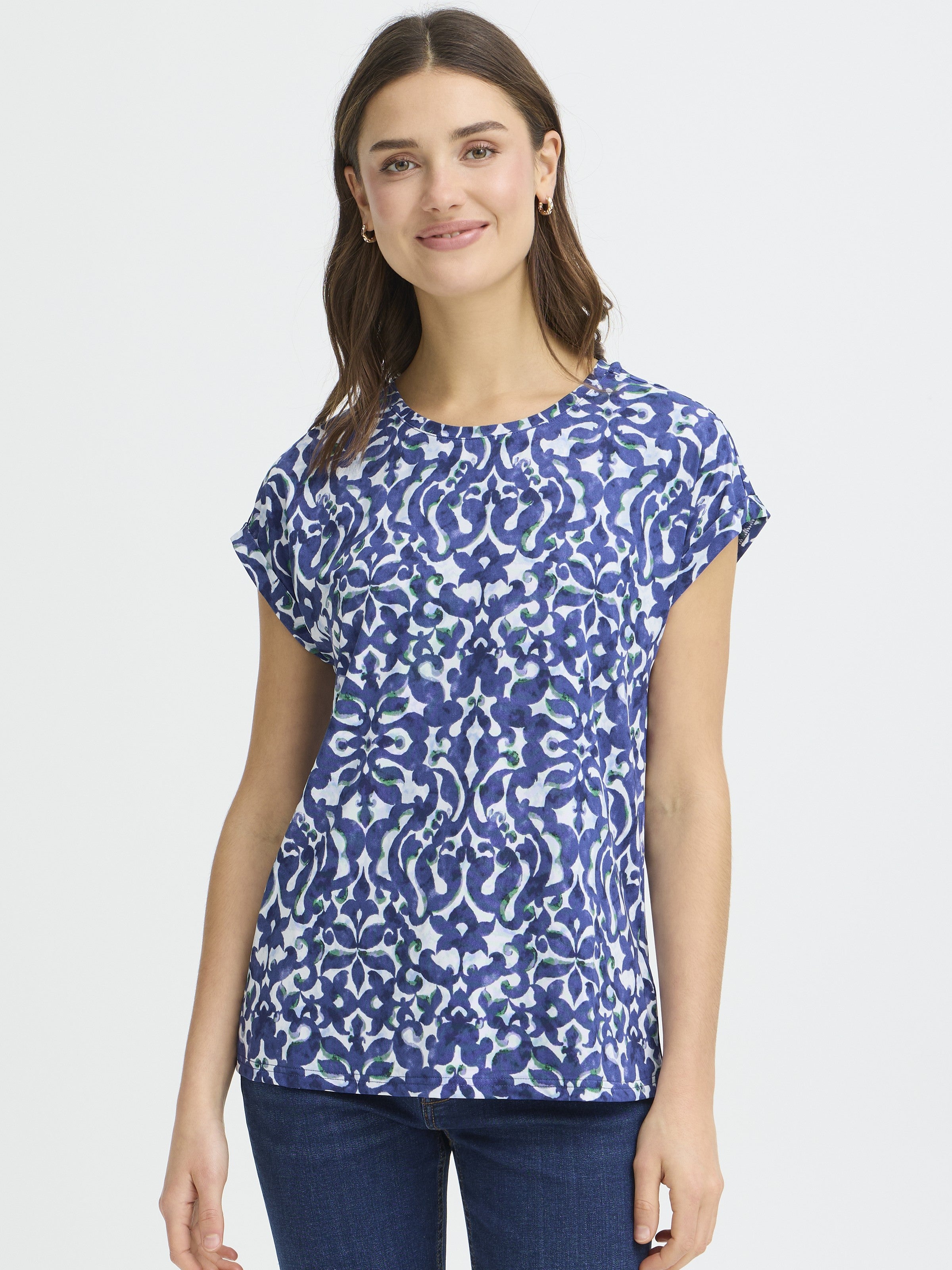 Fransa Seen Short Sleeve Crew Neck Top in blue abstract pattern, styled with dark denim jeans and gold hoop earrings