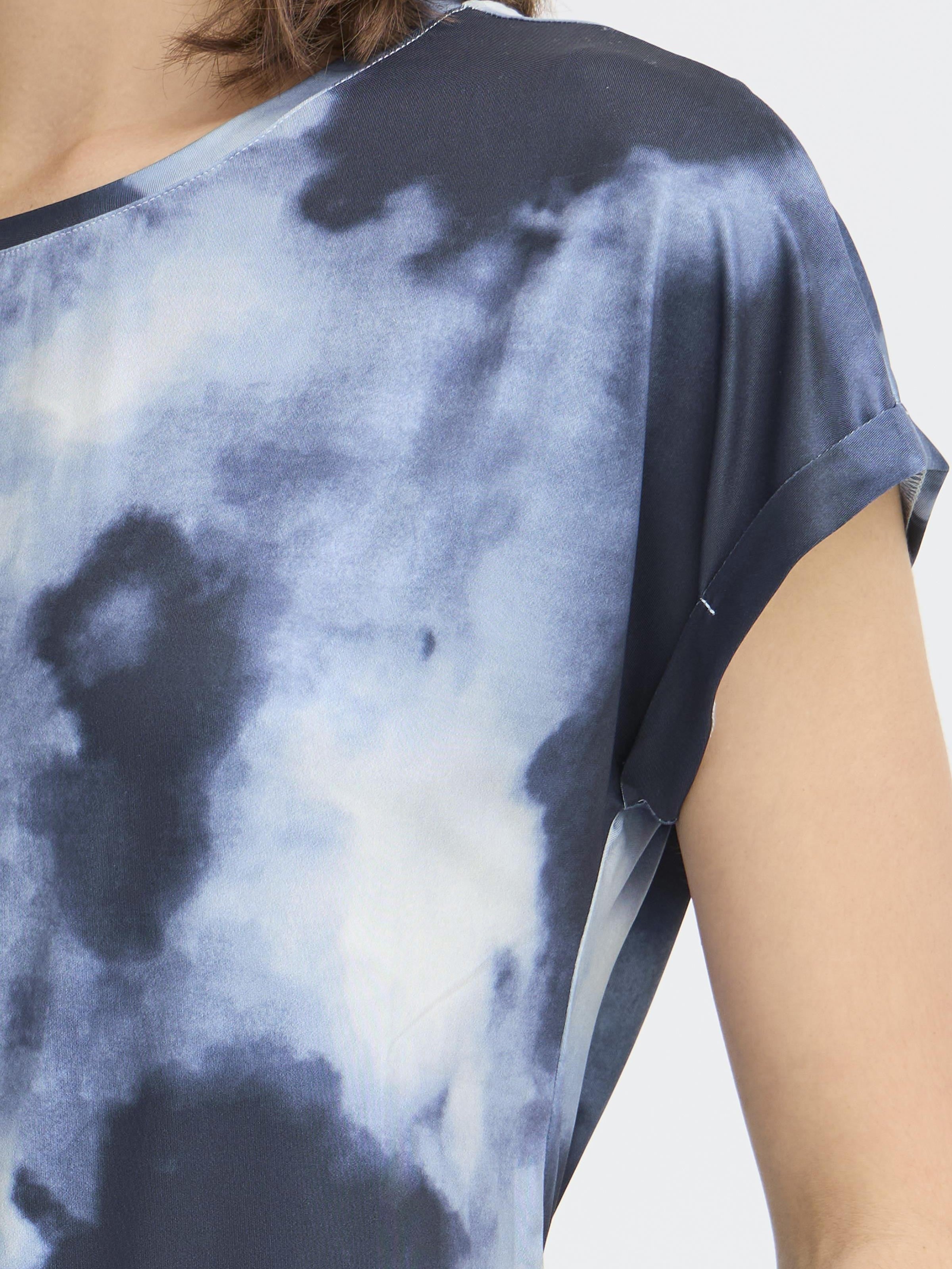 Close-up of blue tie-dye fabric on Fransa Seen Short Sleeve Crew Neck Top by Fransa with rolled sleeves detail.