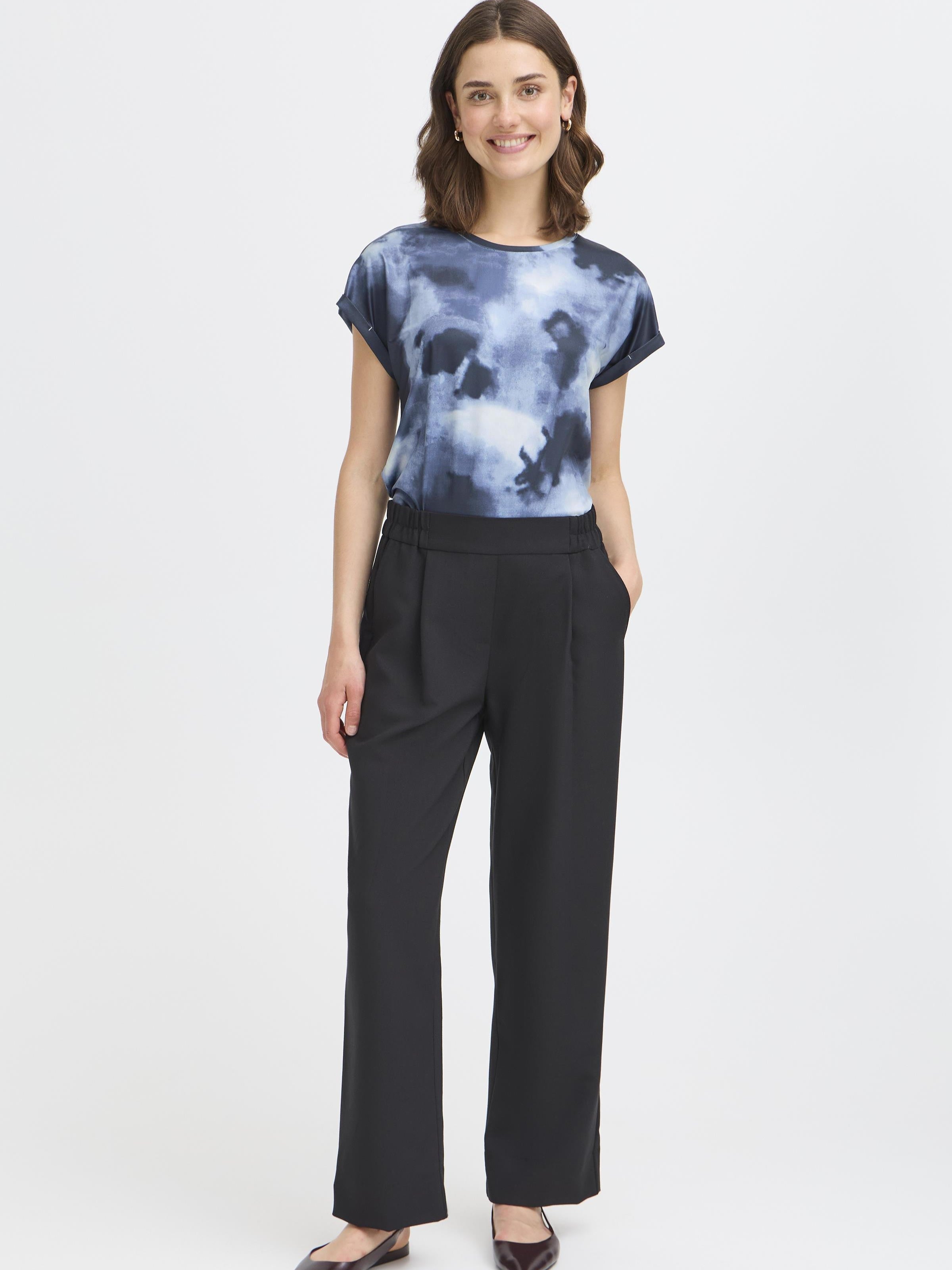 Fransa Seen Short Sleeve Crew Neck Top in blue tie-dye style, paired with black trousers by Fransa.