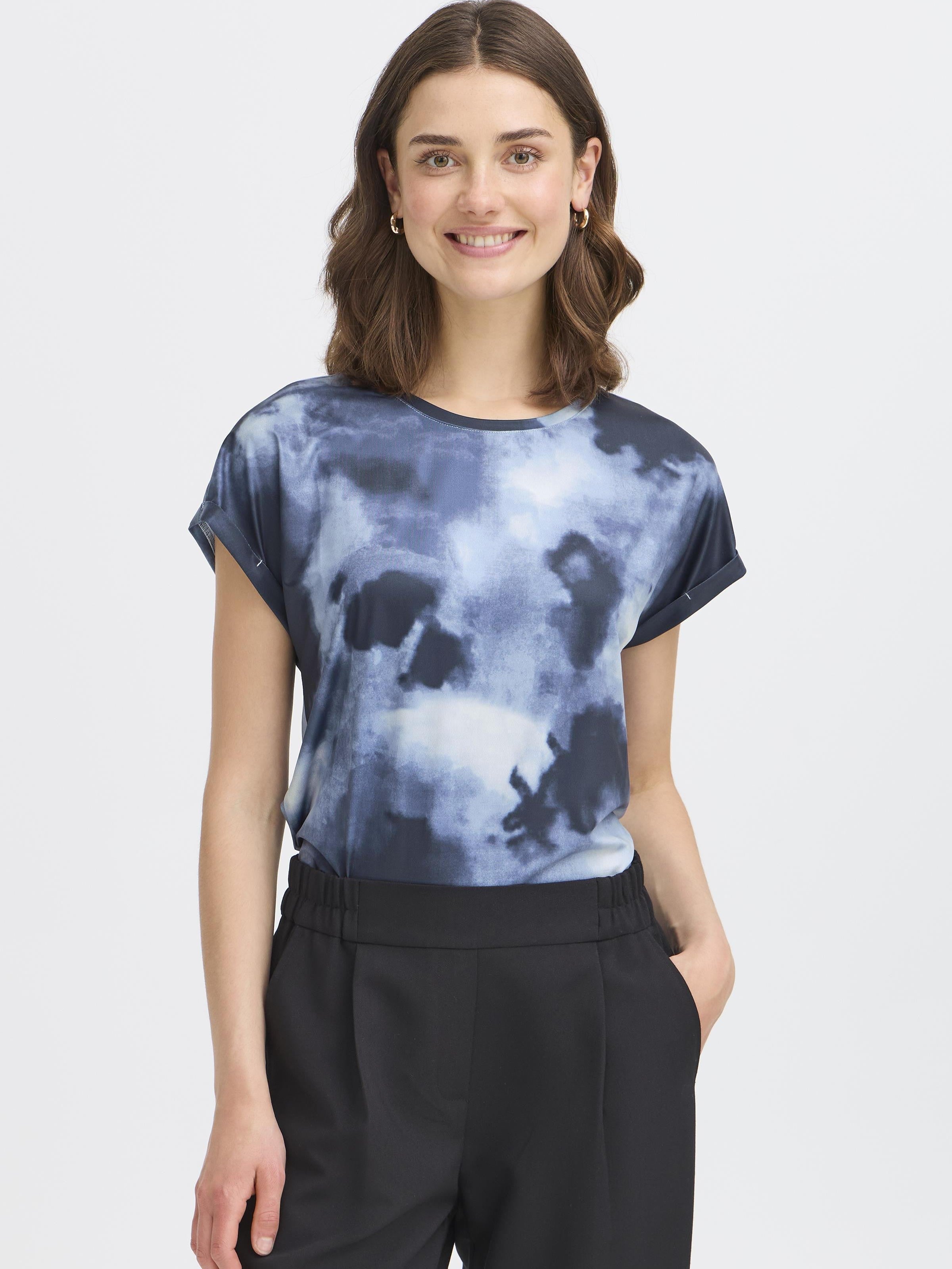 Fransa Seen Short Sleeve Crew Neck Top in blue tie-dye pattern styled with black trousers by Fransa
