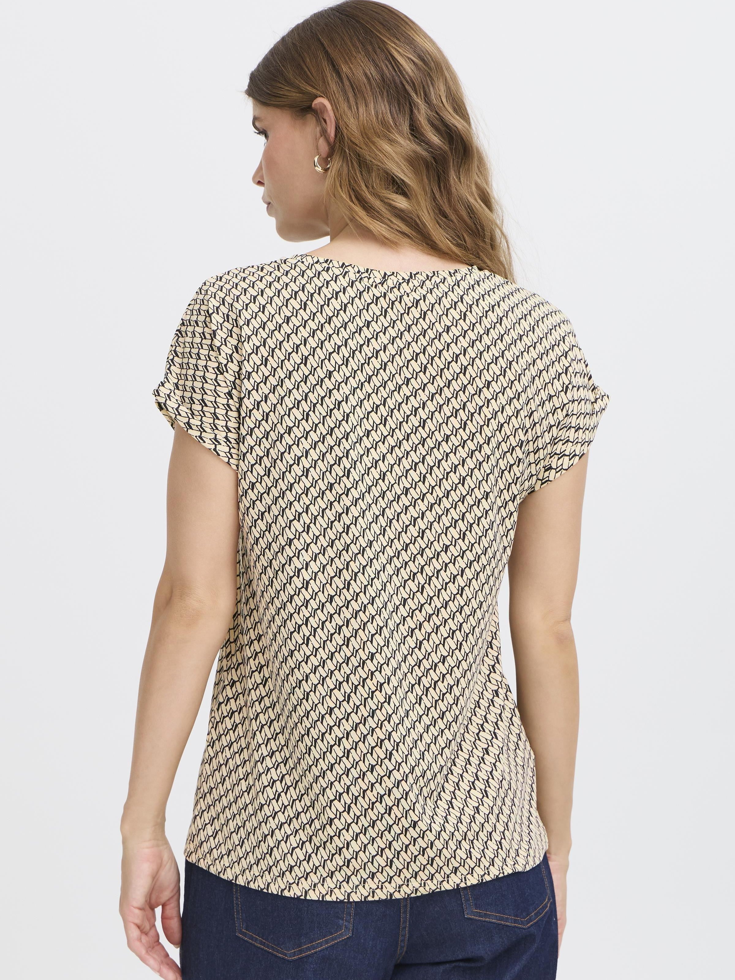 Back view of Fransa Seen Short Sleeve Crew Neck Top in patterned fabric by Fransa, paired with denim bottoms.