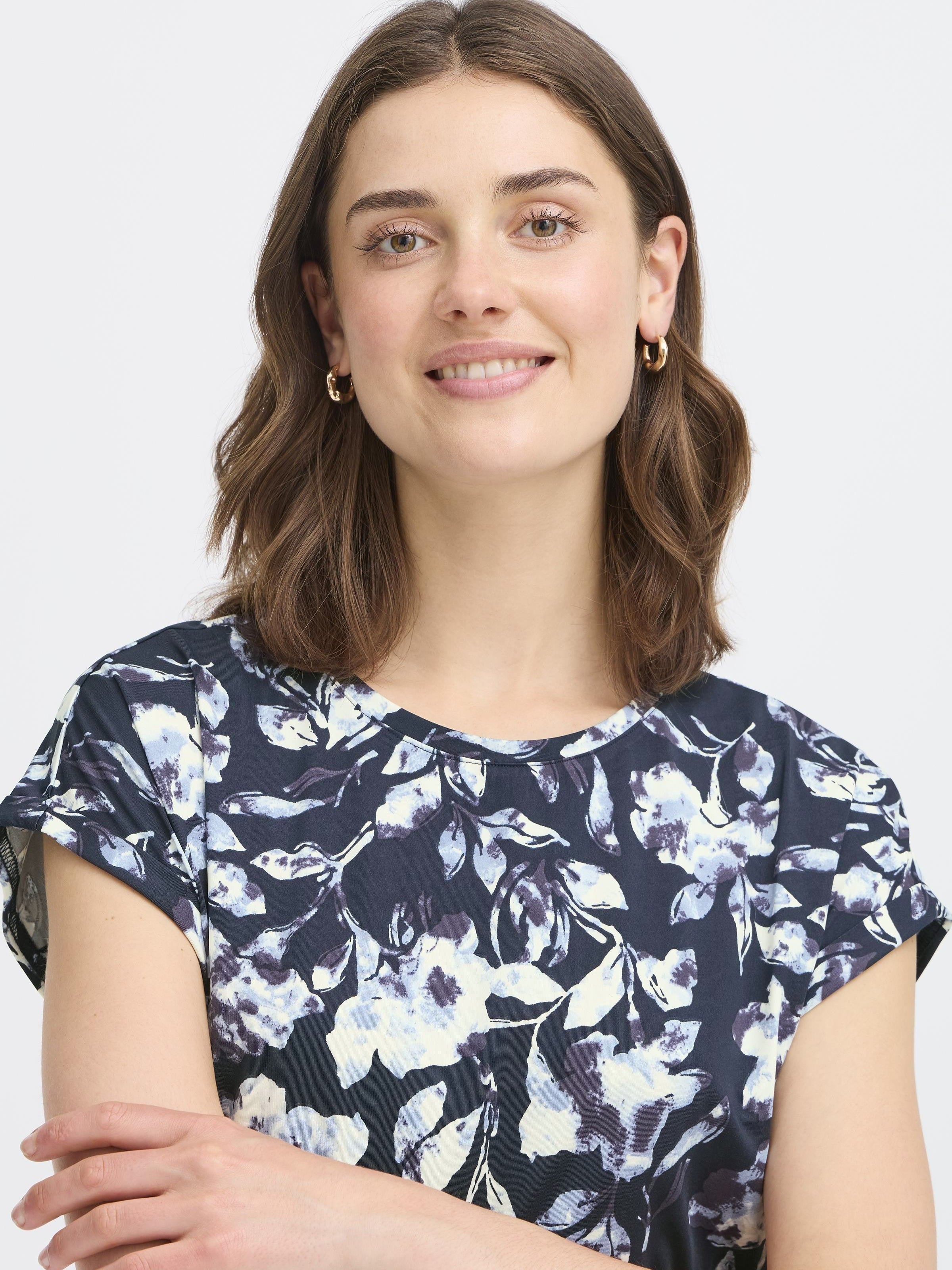 Fransa Seen Short Sleeve Crew Neck Top in navy with a white floral print, styled with gold hoop earrings