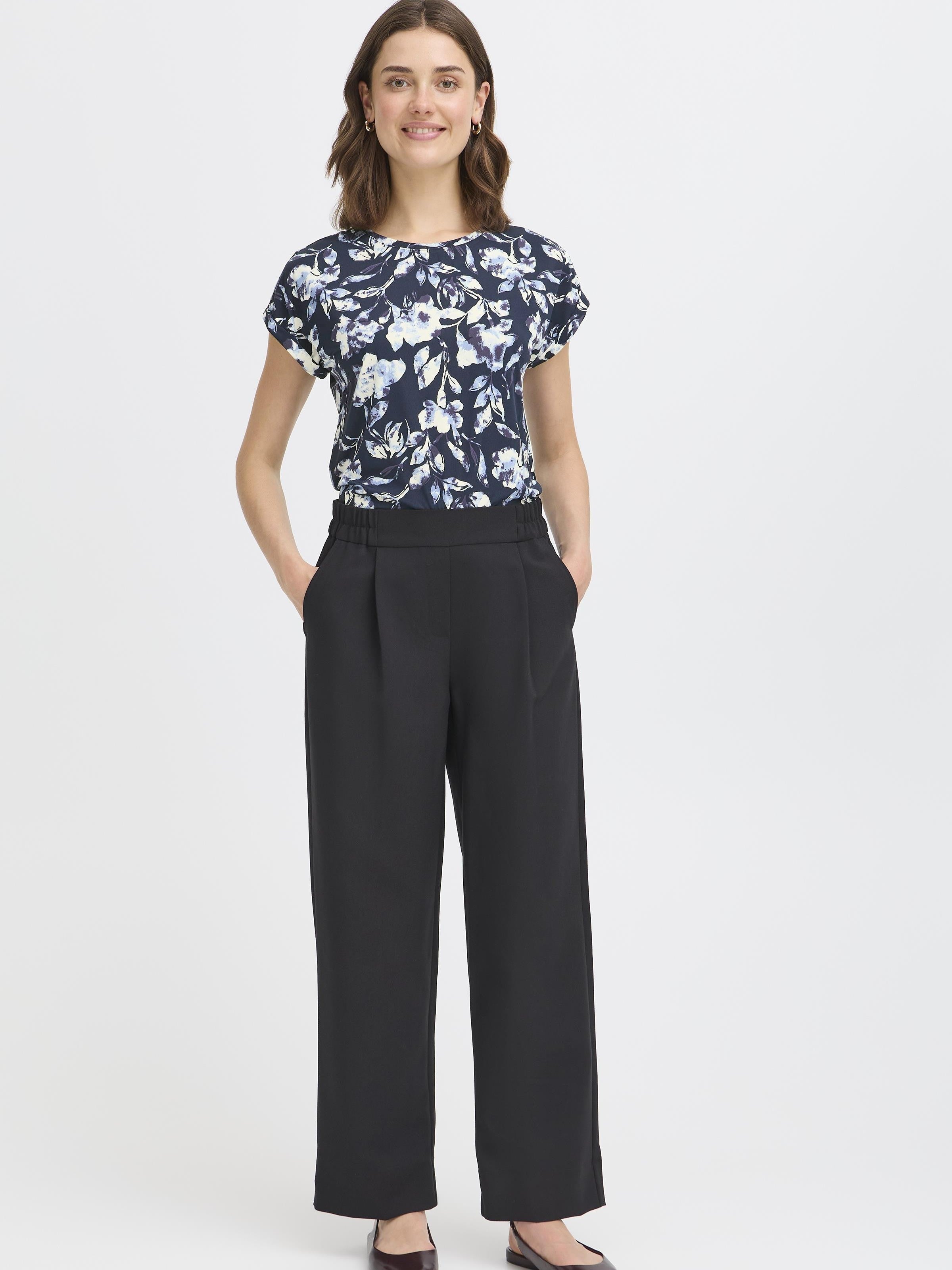 Fransa Seen Short Sleeve Crew Neck Top in navy with white floral print, styled with black wide-leg pants by Fransa