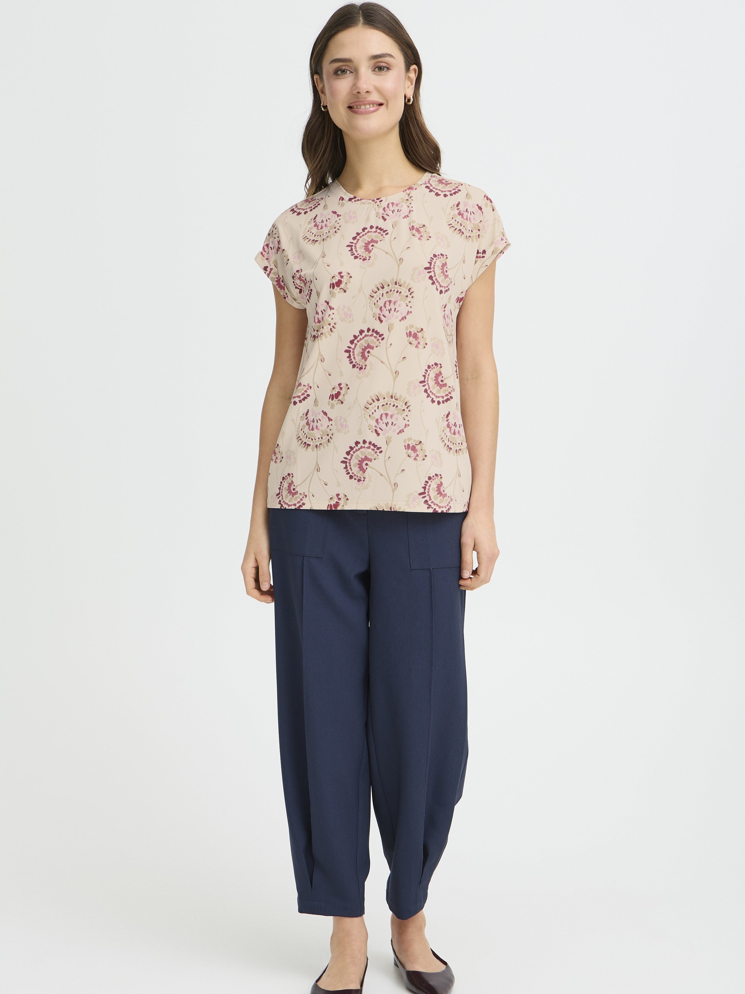 Fransa Seen Short Sleeve Crew Neck Top in off-white with pink floral print, styled with navy pants by Fransa.