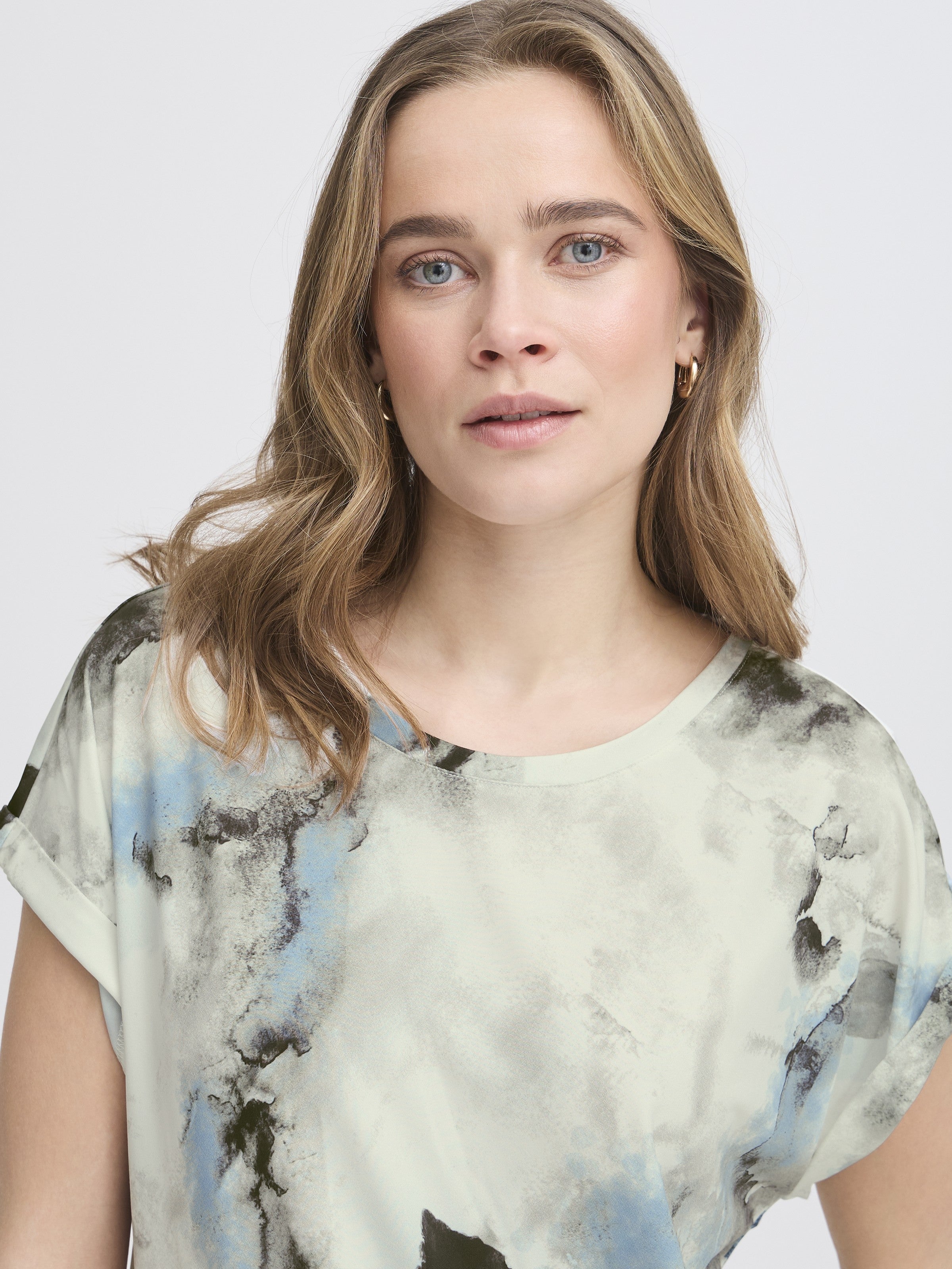 Close-up of a light abstract patterned Fransa Seen Short Sleeve Crew Neck Top in soft tones by Fransa