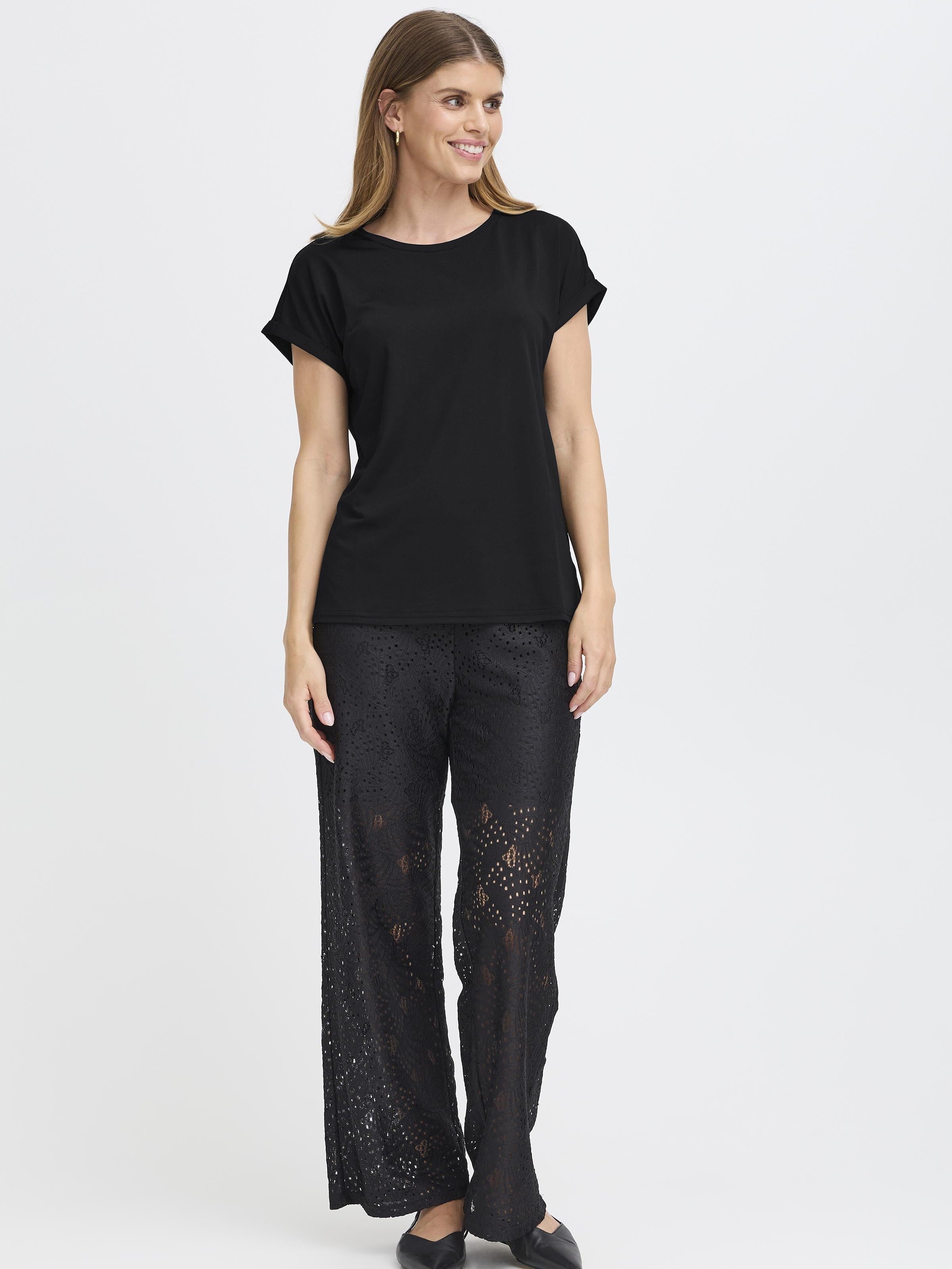 Fransa Seen Short Sleeve Crew Neck Top in black paired with stylish wide-leg lace pants and black flats