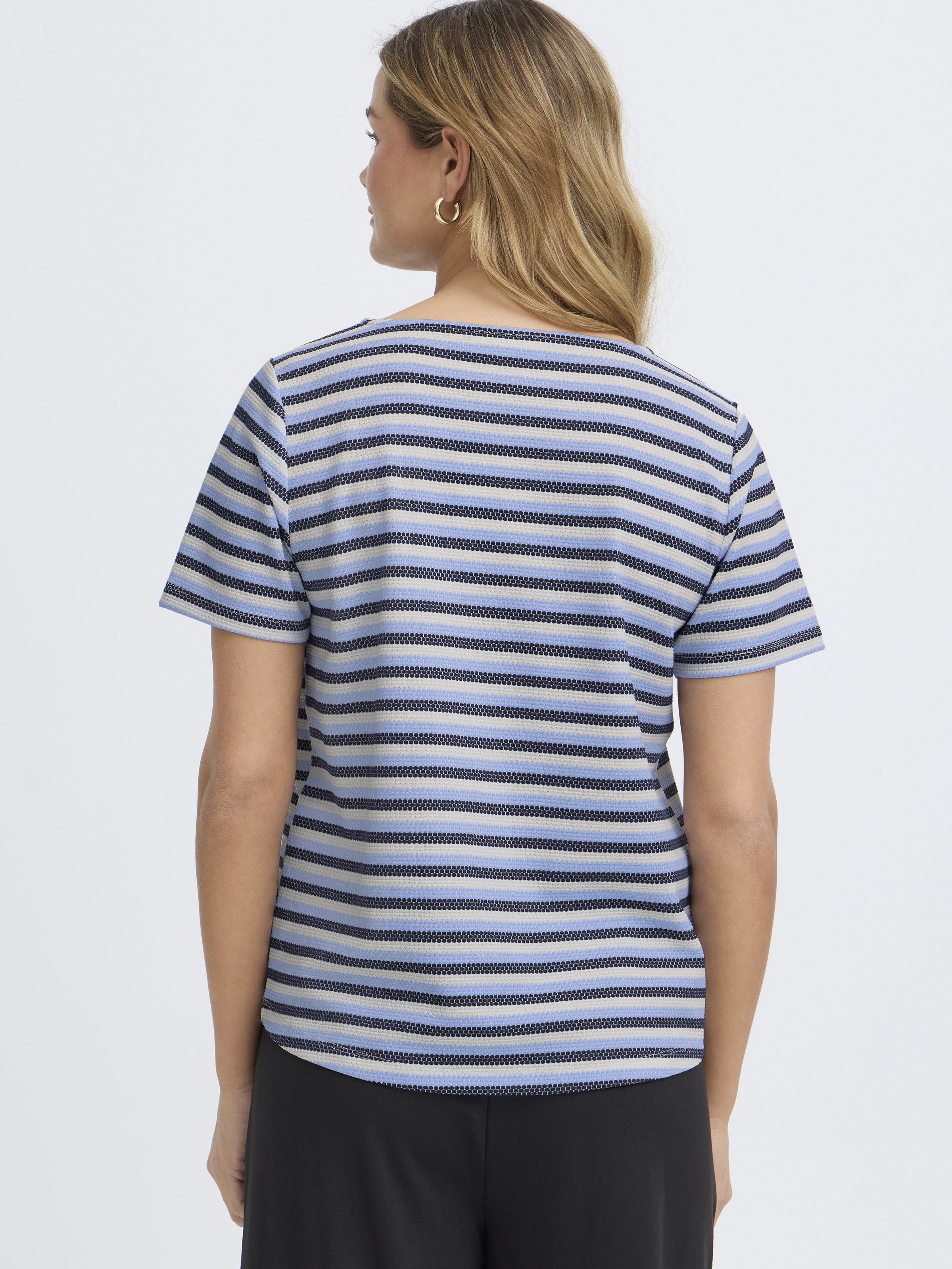 Back view of a striped blue and white Fransa Josie Striped Short Sleeve Top on model with black pants