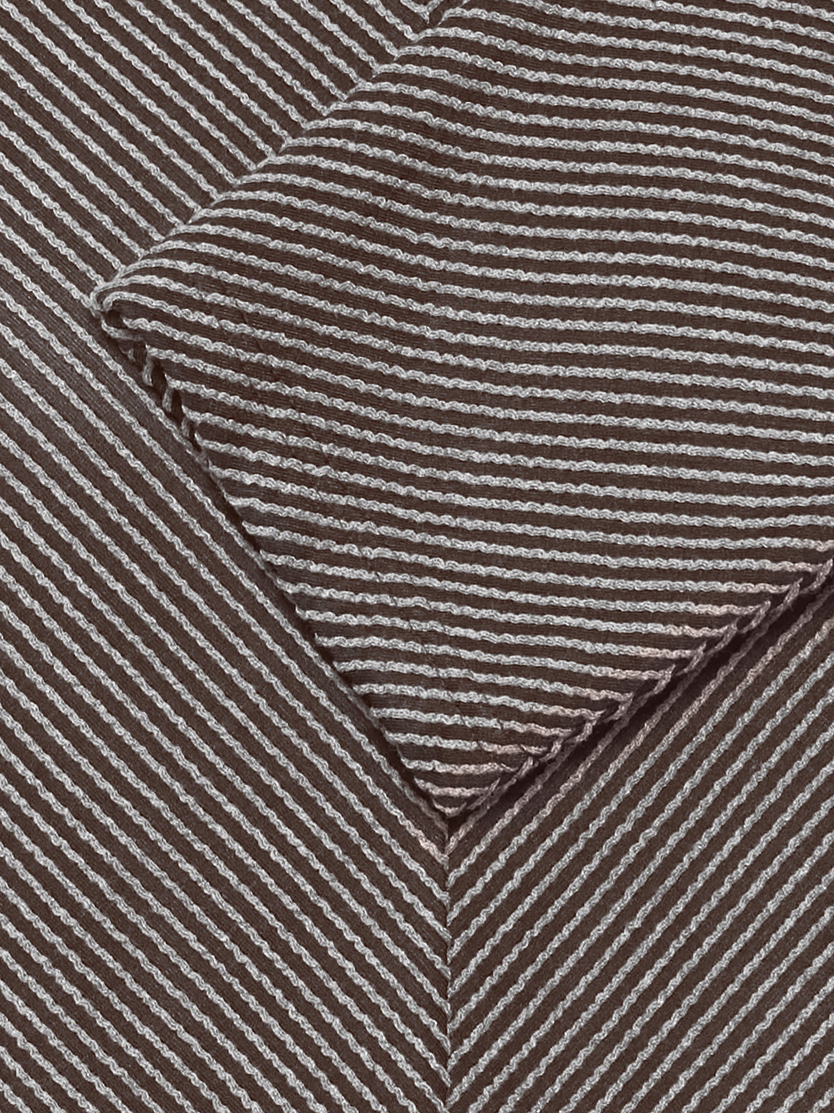 Close up of brown and cream striped fabric with a pointed folded detail