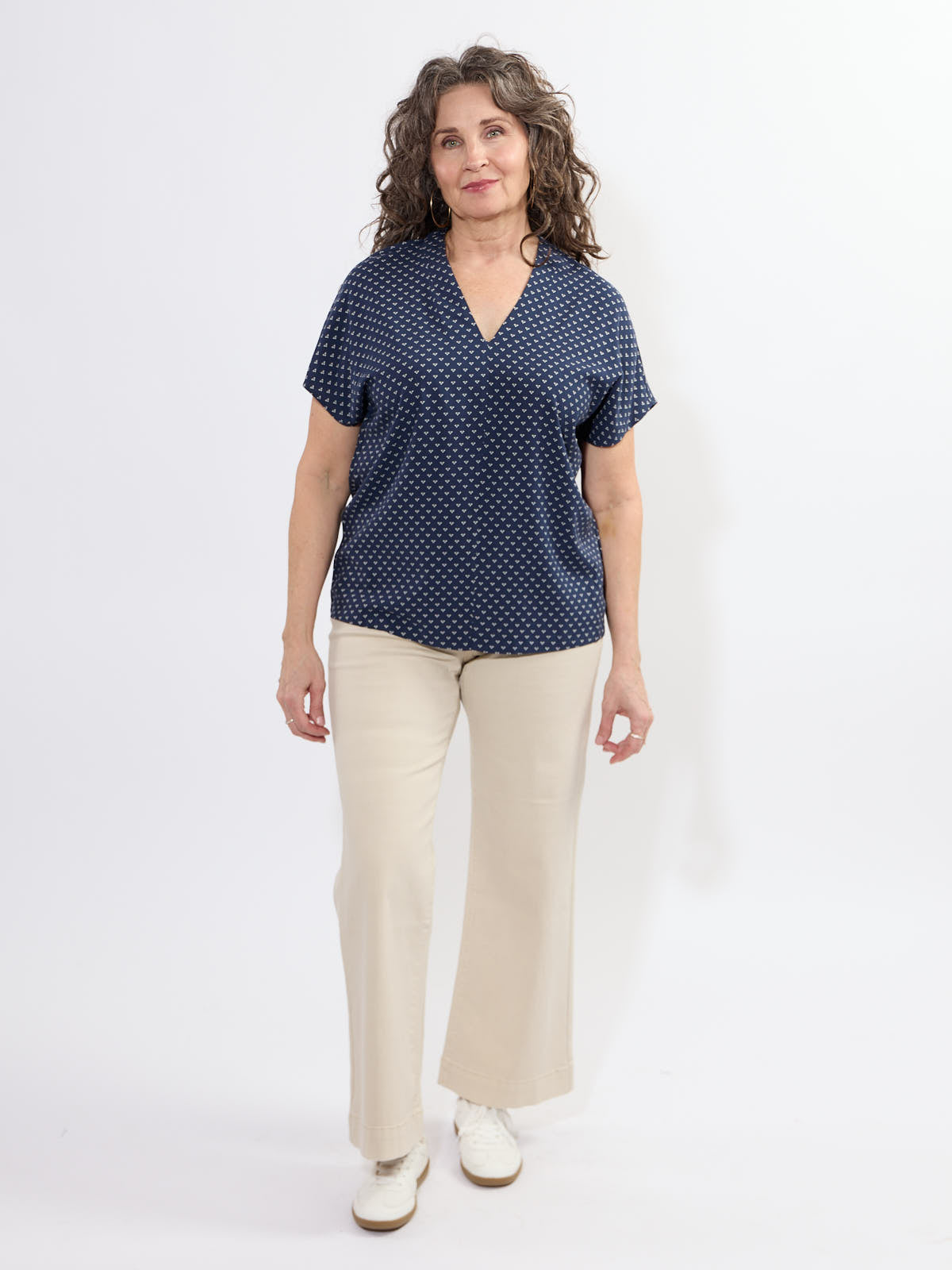 Fransa Justine Heart Print Short Sleeve V-Neck Top in navy with beige pants, styled by Fransa, casual tops fashion.