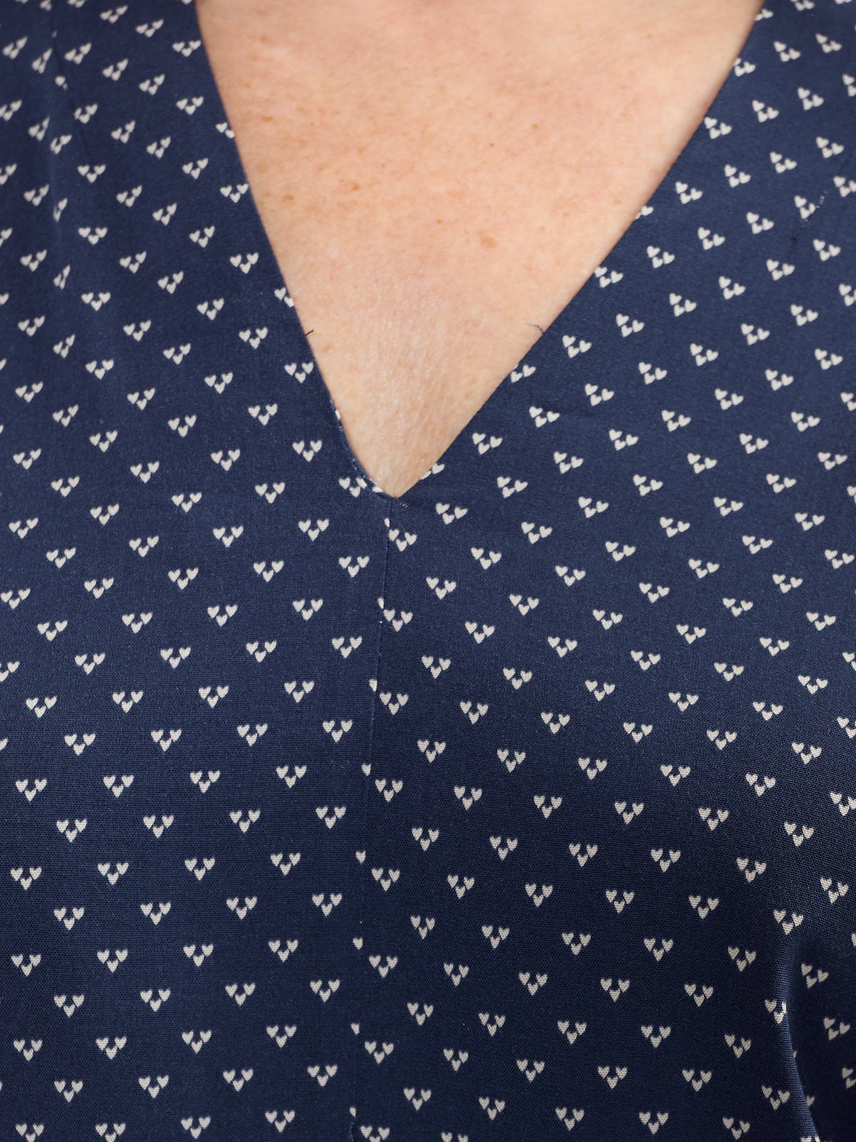 Close-up of navy fabric with small white heart print on Fransa Justine Heart Print Short Sleeve V-Neck Top by Fransa