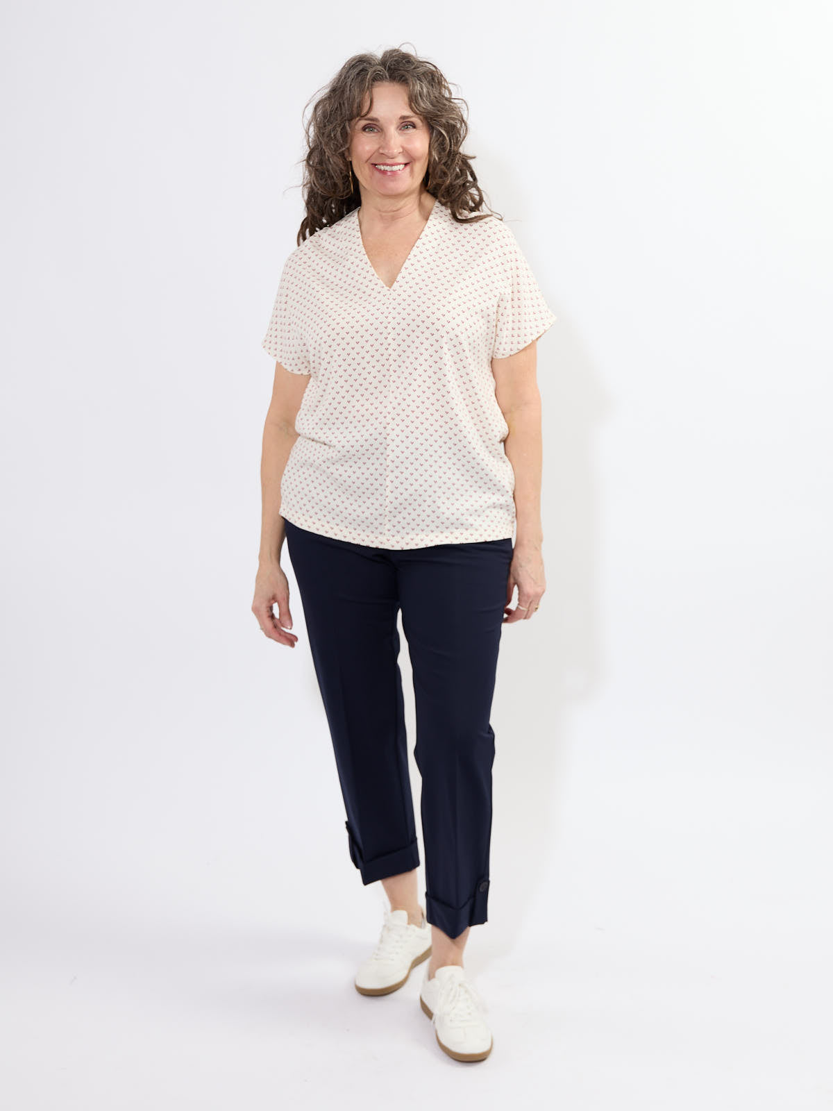 Fransa Justine Heart Print Short Sleeve V-Neck Top in off-white heart pattern paired with navy pants by Fransa.