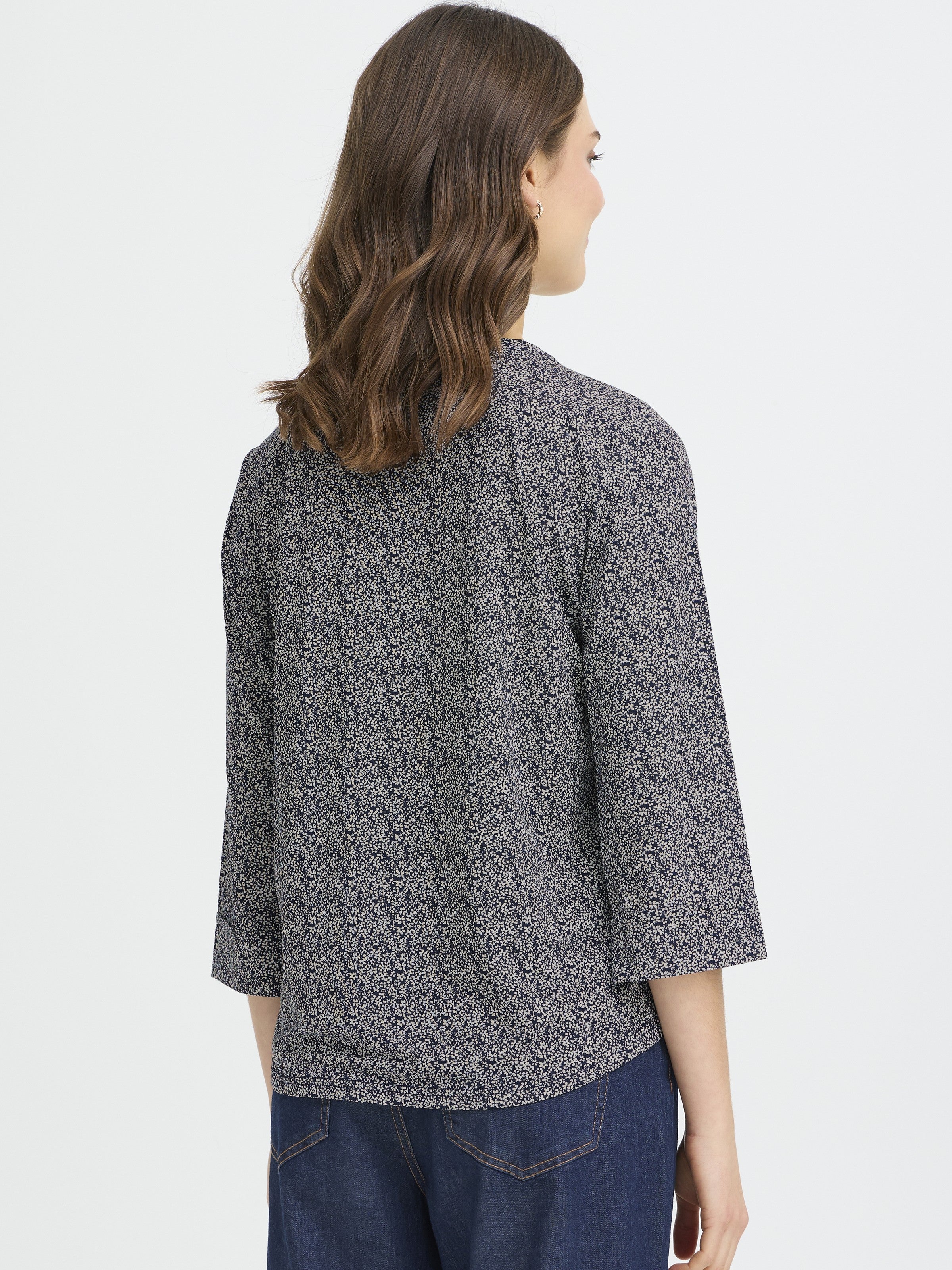 Fransa Seen Three-Quarter Sleeve Cuff Top in navy with a subtle floral pattern worn with dark denim jeans