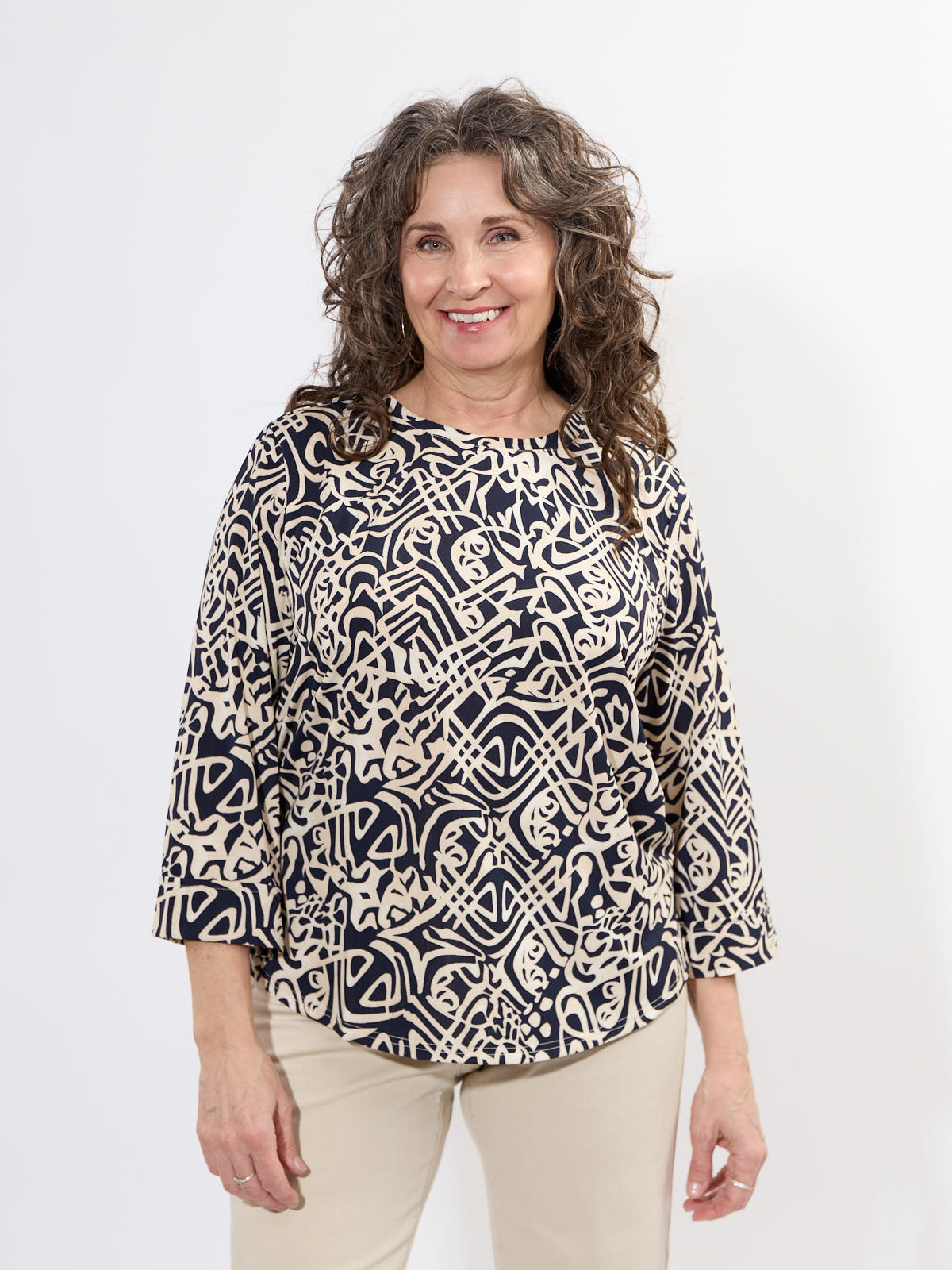 Fransa Seen Three-Quarter Sleeve Cuff Top in navy and beige abstract pattern by Fransa, styled with light pants.