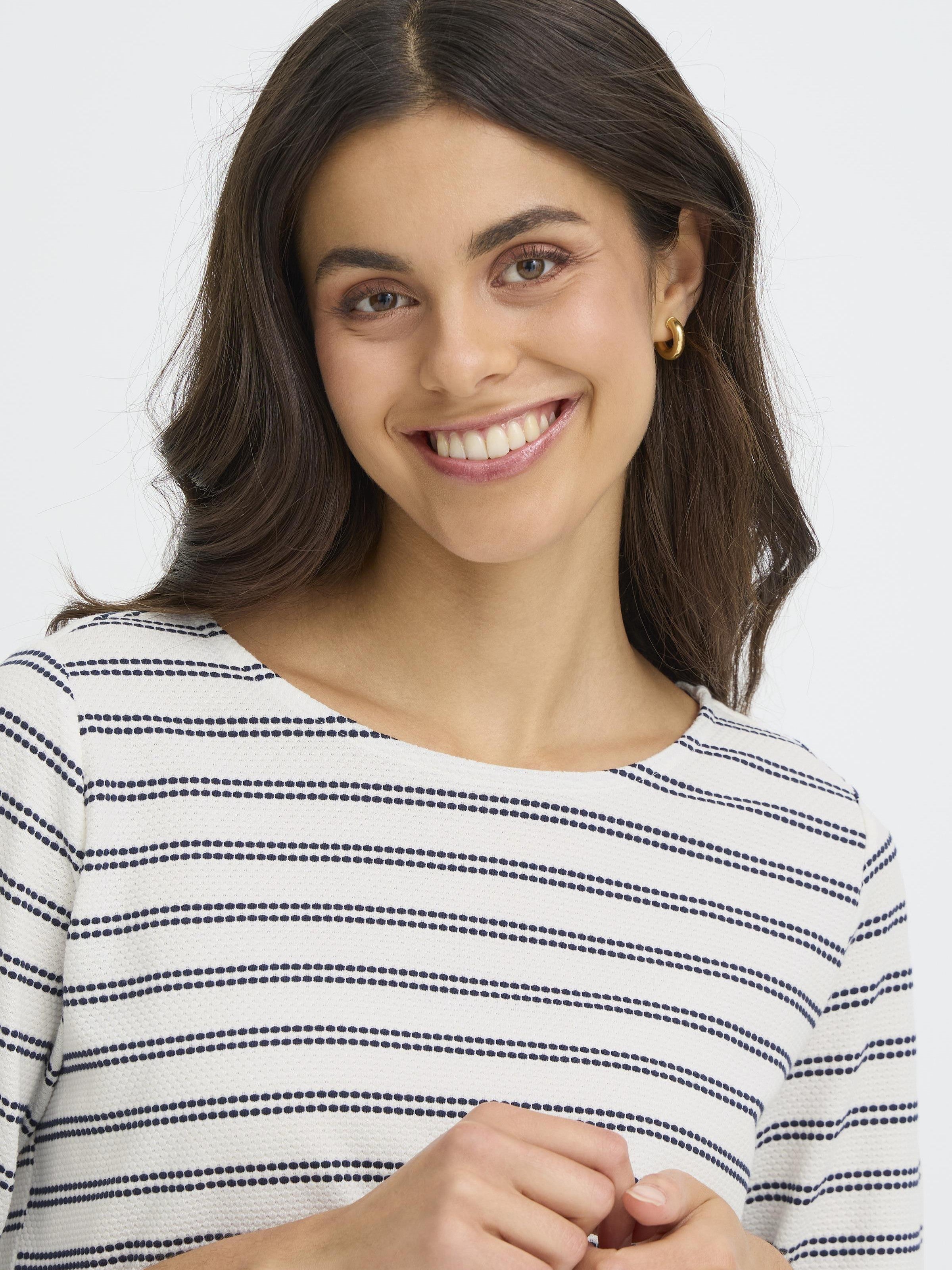 Close-up of a smiling model wearing Fransa Josie Striped Three-Quarter Sleeve Crew Neck Top in off-white with navy stripes